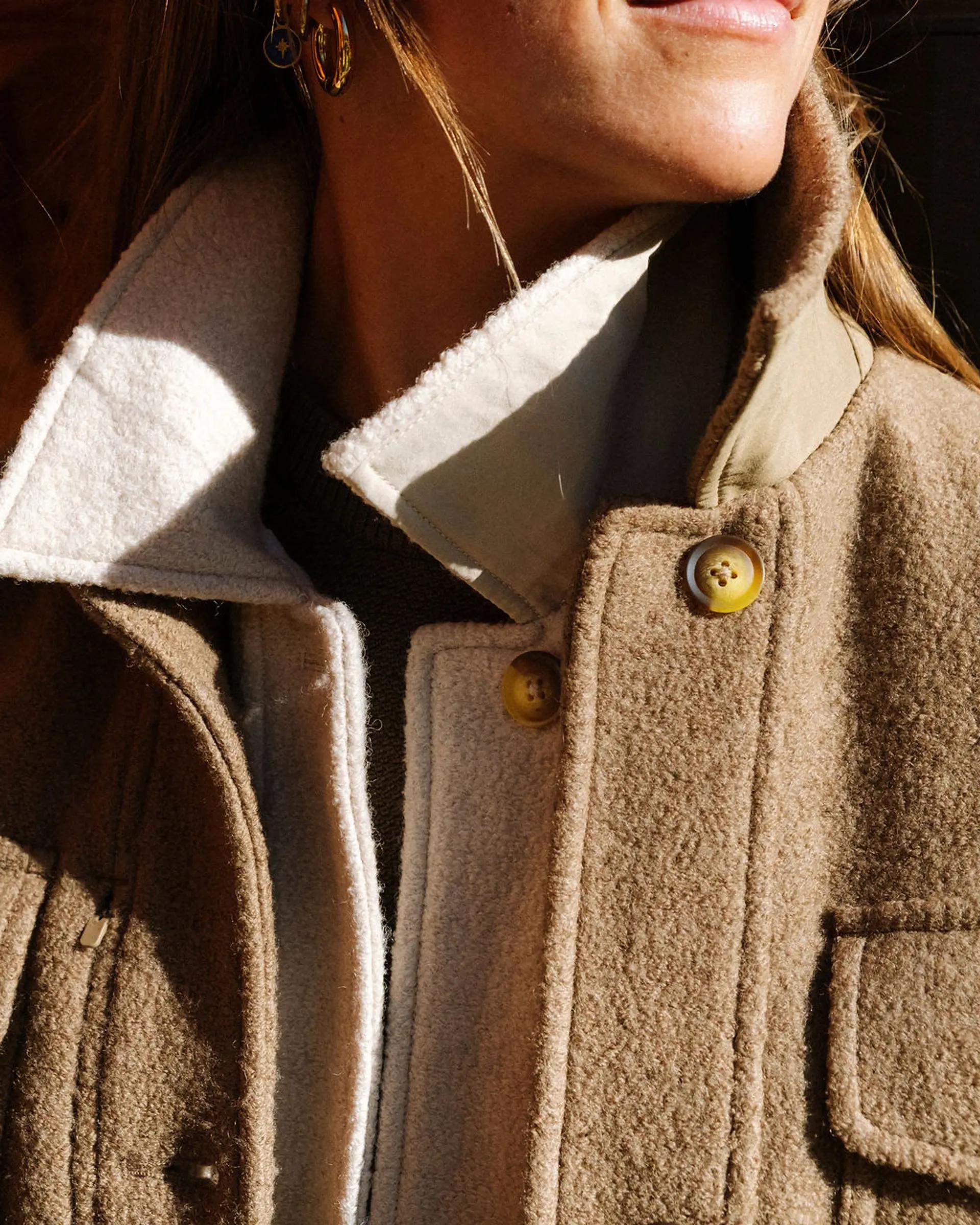A skier wearing 2 sport coat jackets