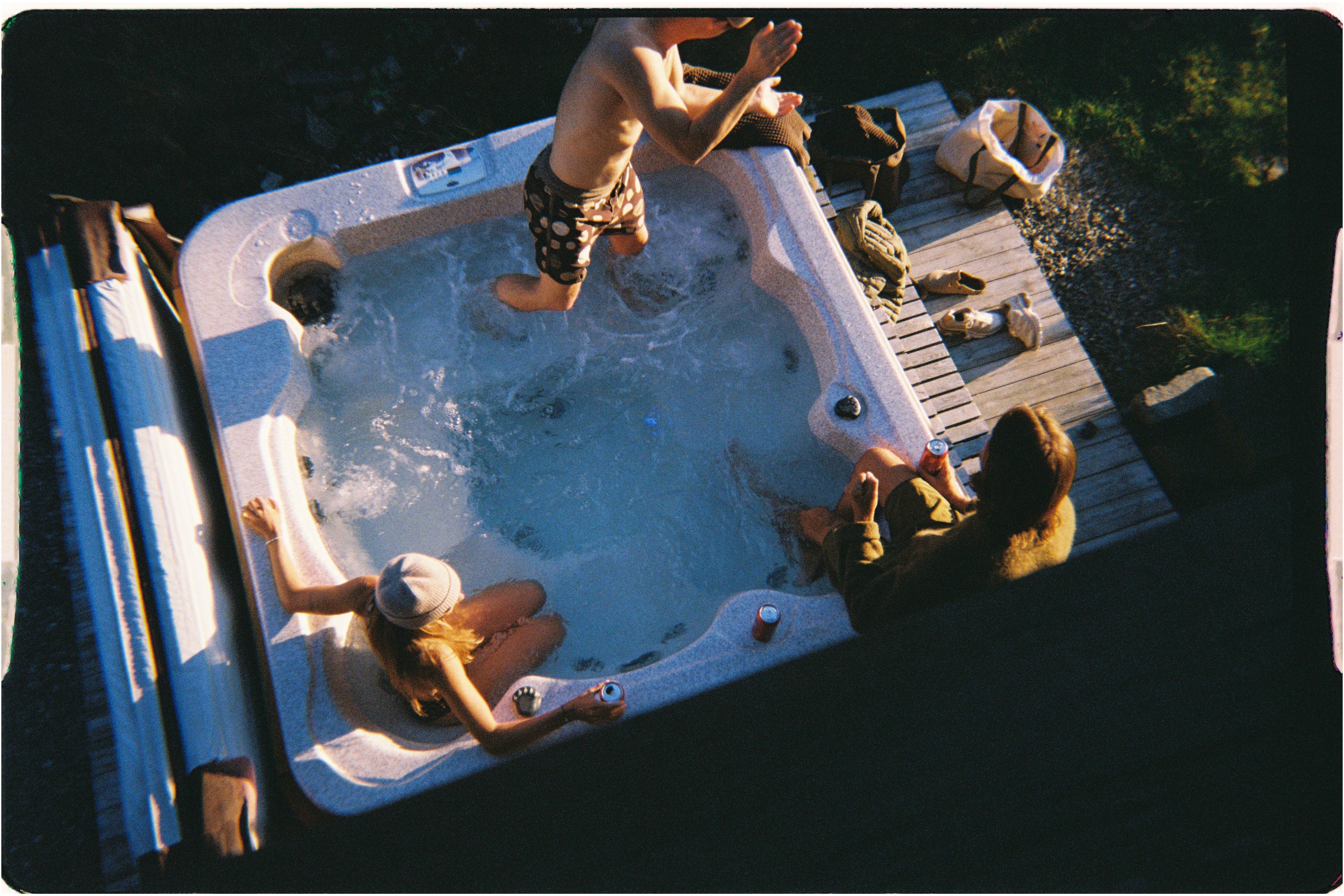 A photo of people in a hot tub with Yardsale Day Bags nearby