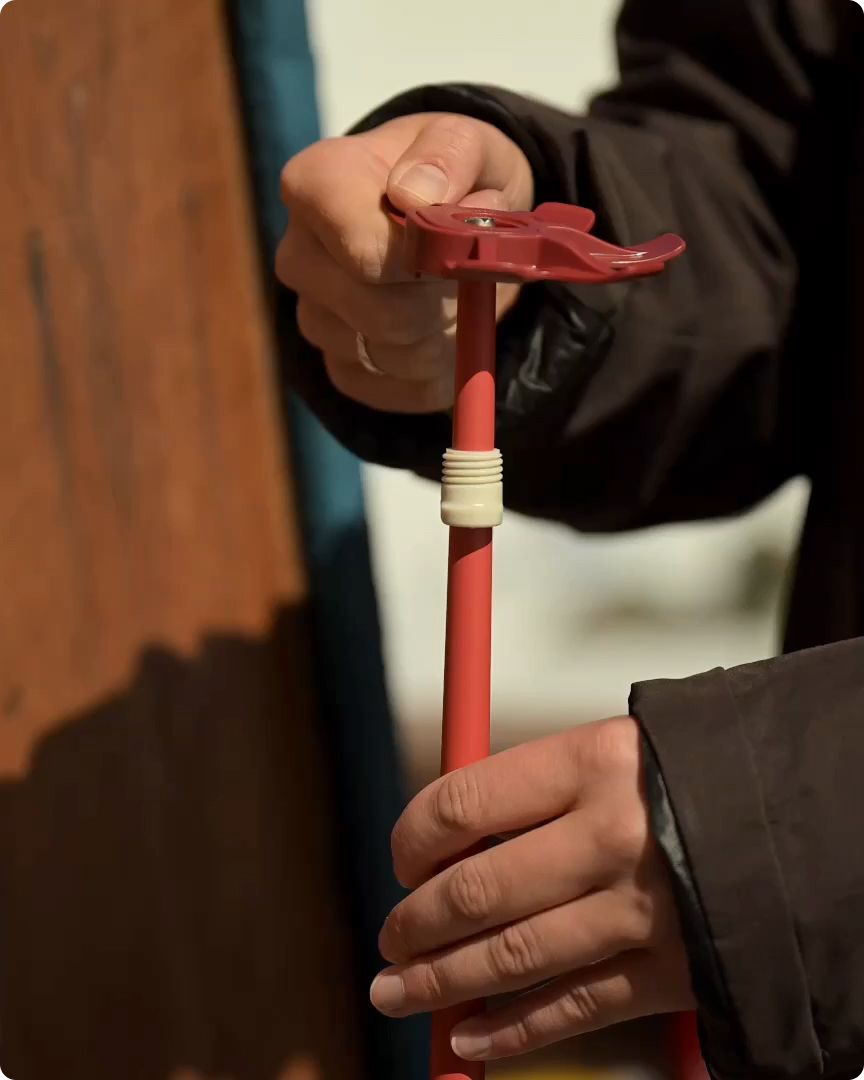 An image of a hand holding poles horizontally