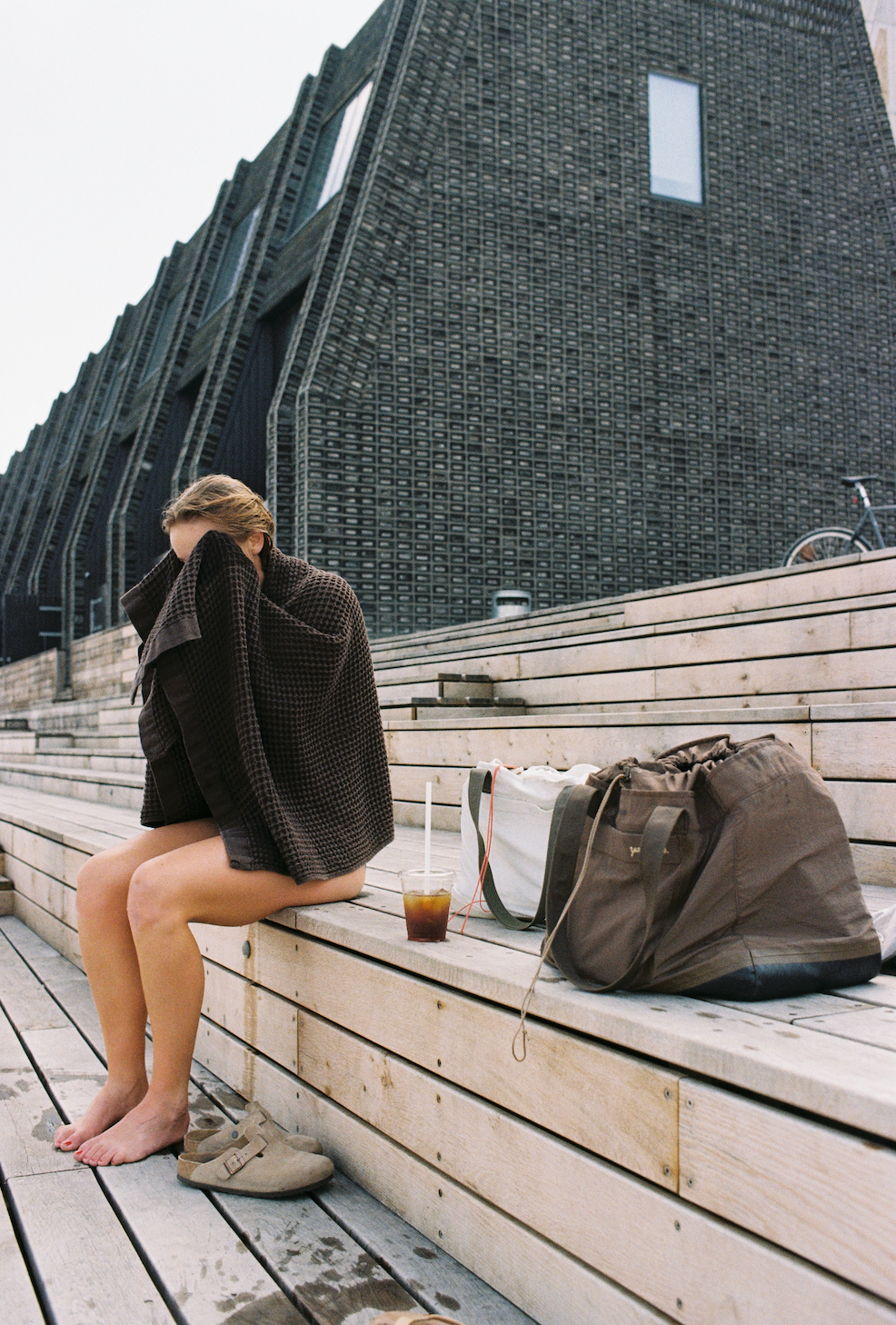 Image of someone on a dock drying off