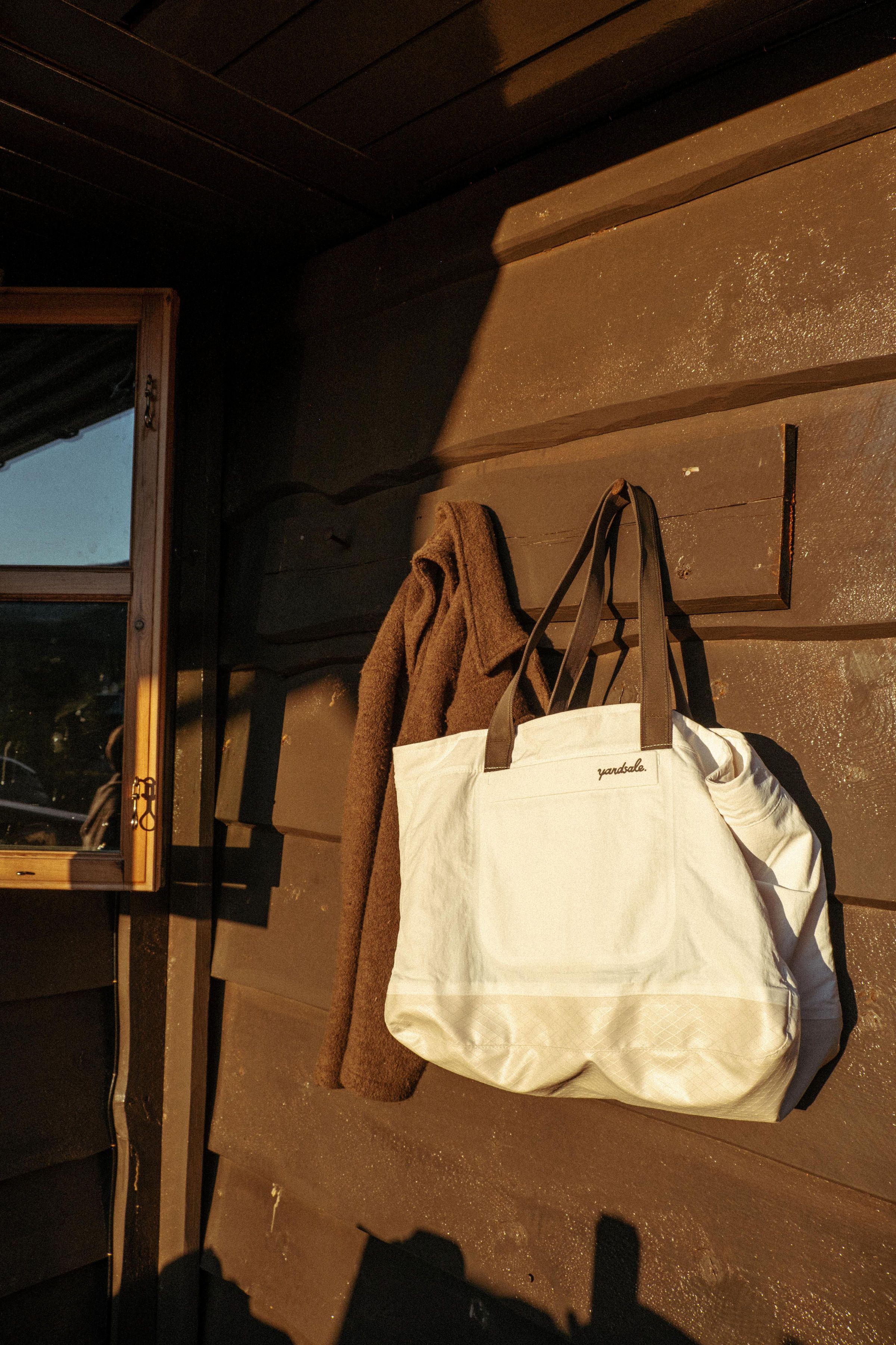 An image of a bag hanging from a coat rack