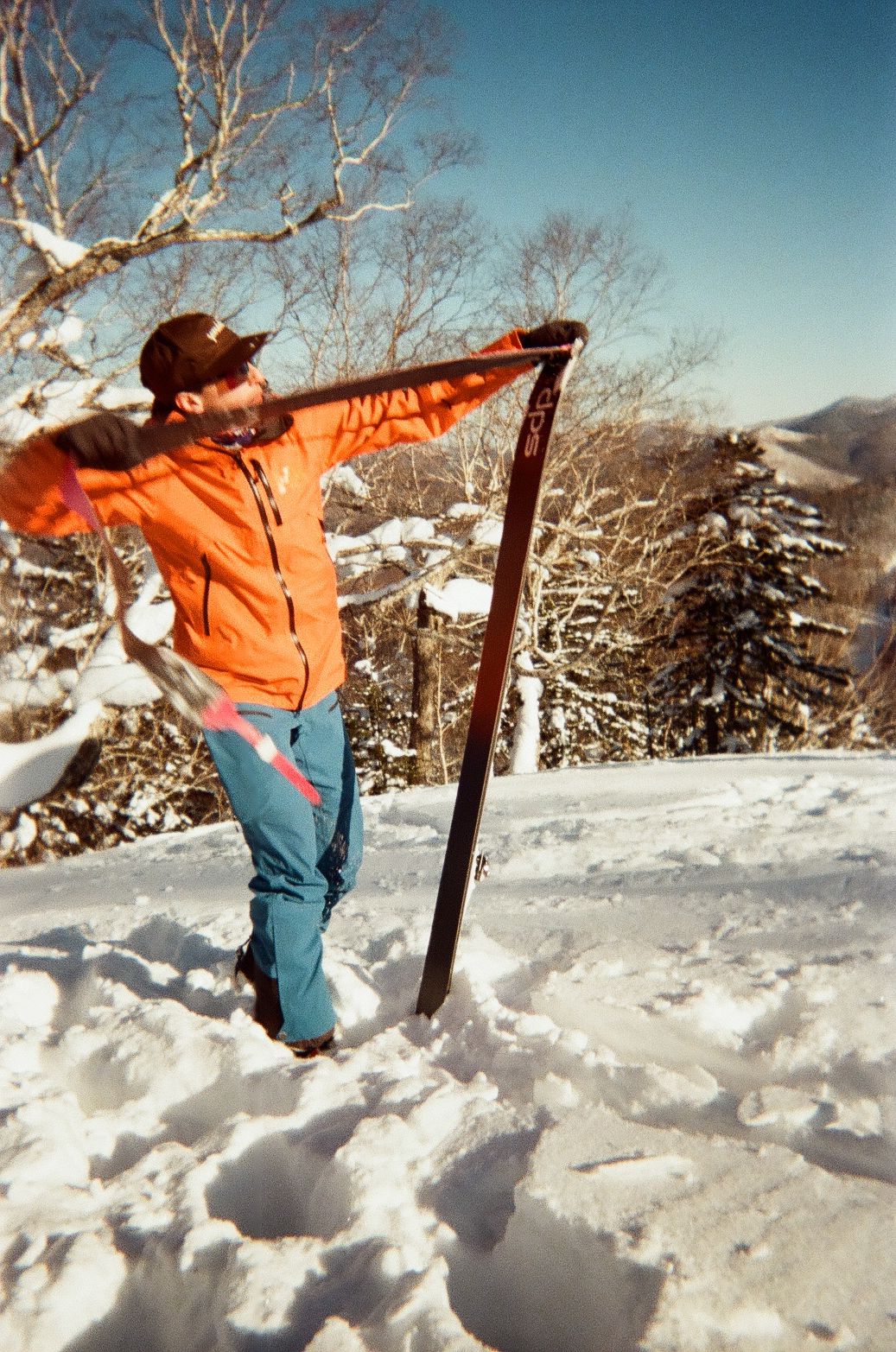 An image of a skier taking skins off in the backcountry