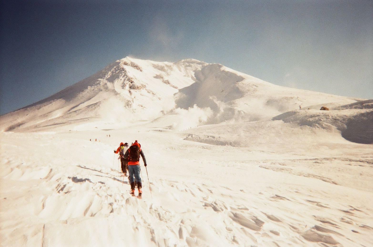 An image of skiers going up a snowy mountain