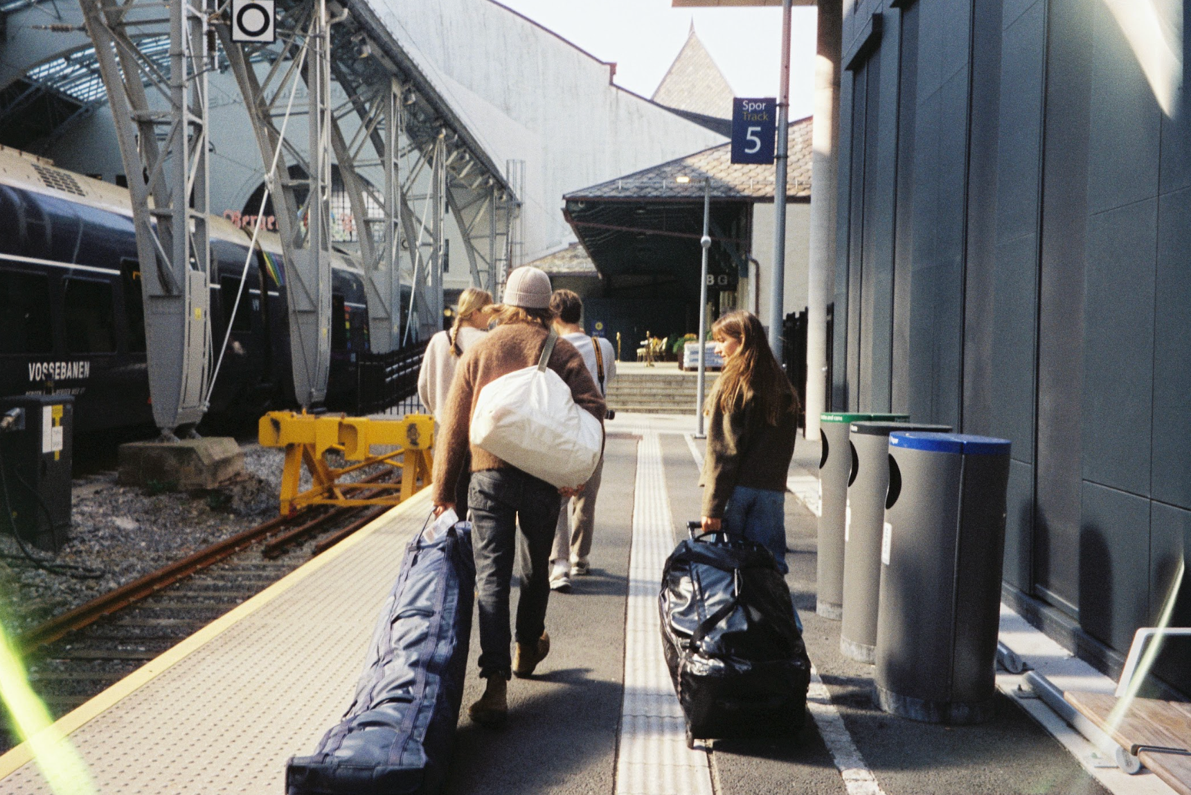 An image of people traveling with ski bags
