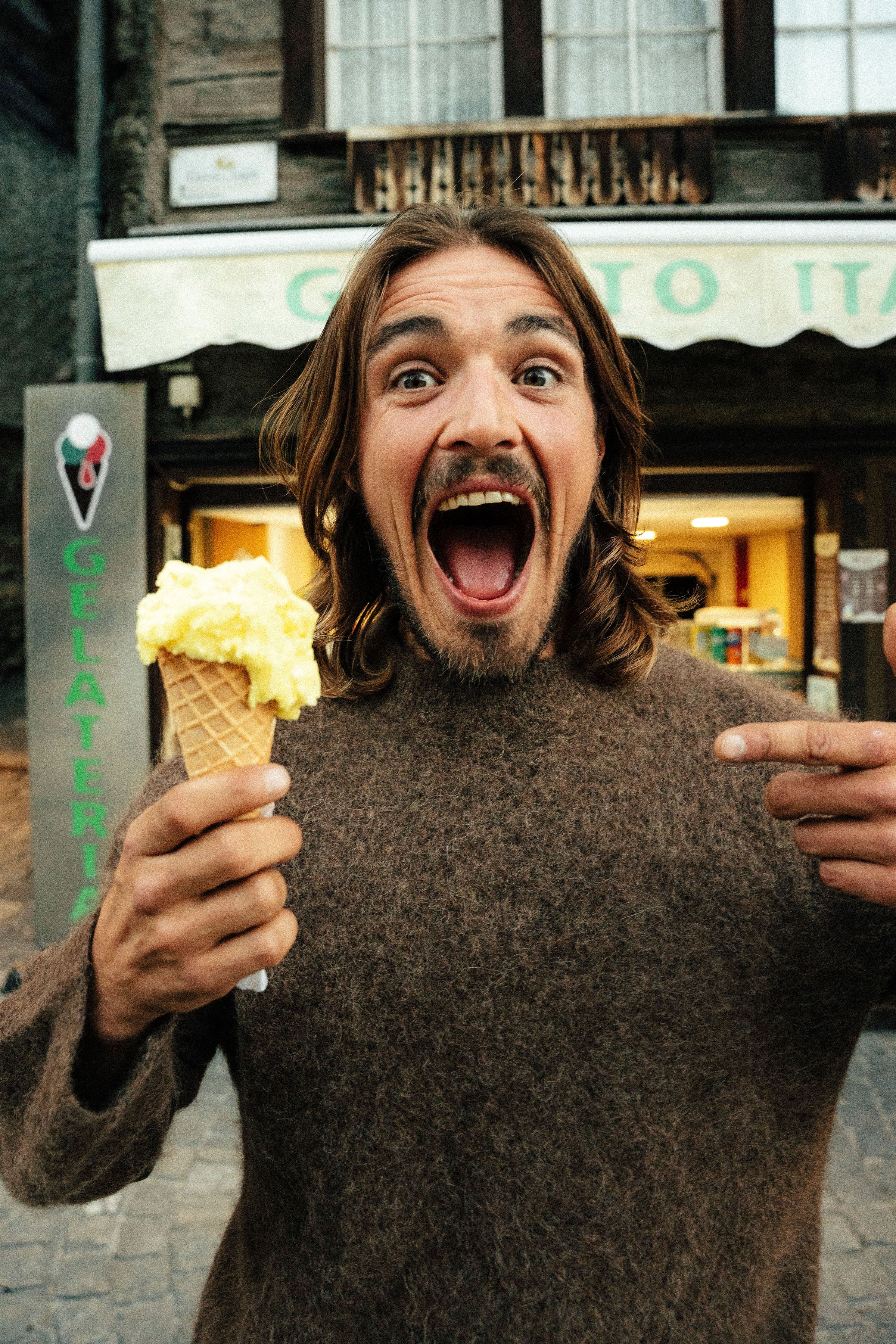 An image of a man smiling with ice cream