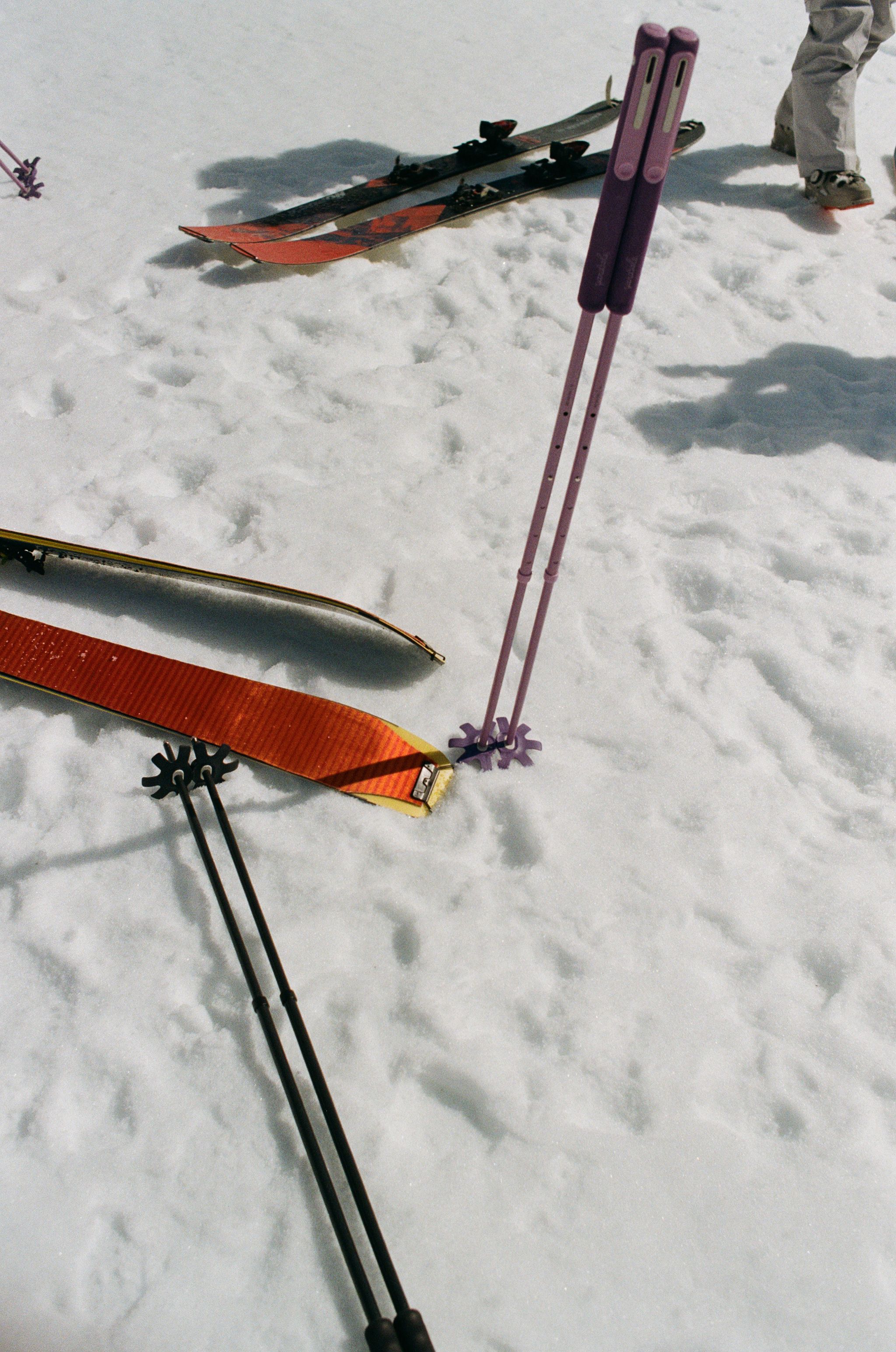 An image of backcountry ski poles on the snow