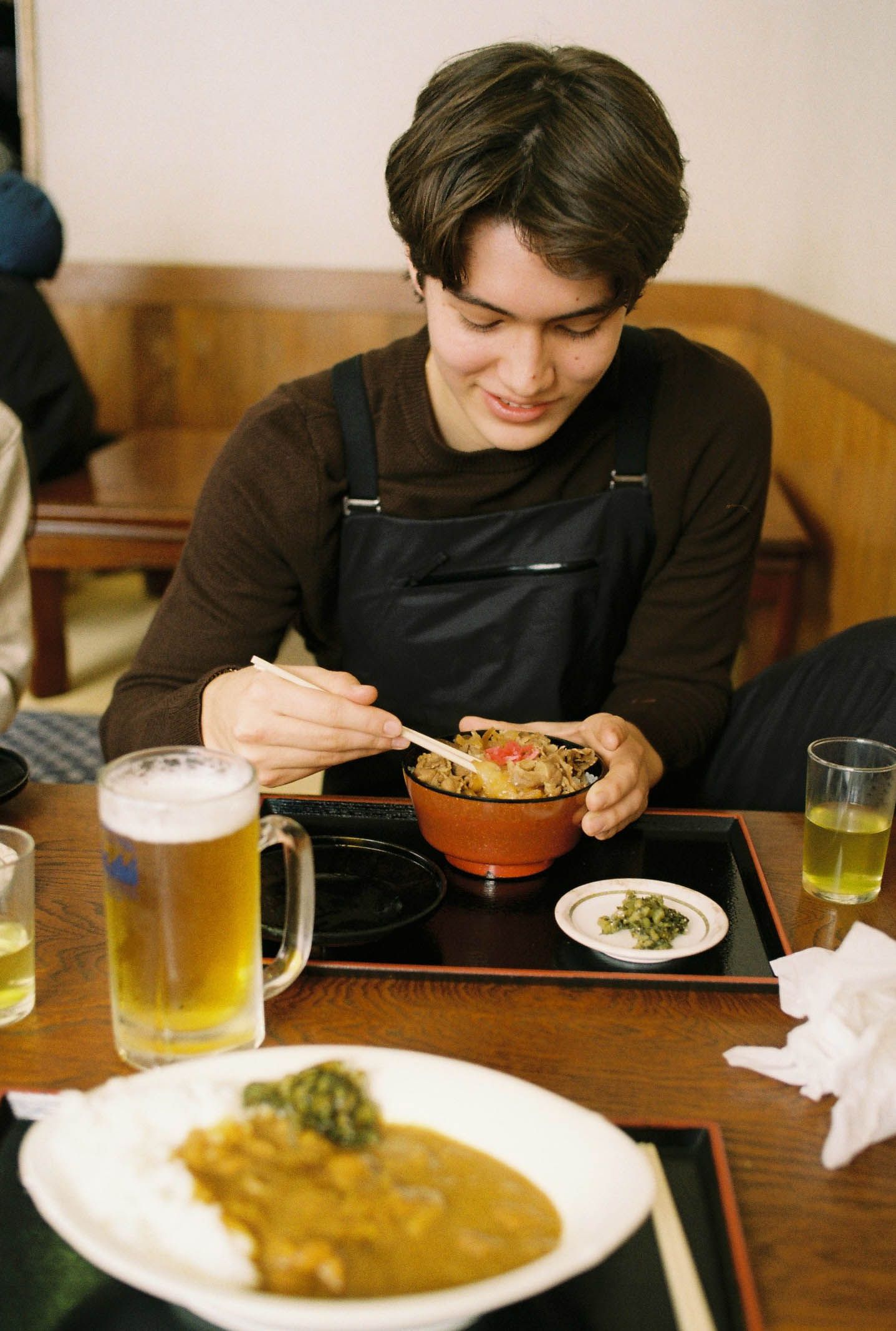 An image of man eating lunch at a ski resort in Nozawa, Japan