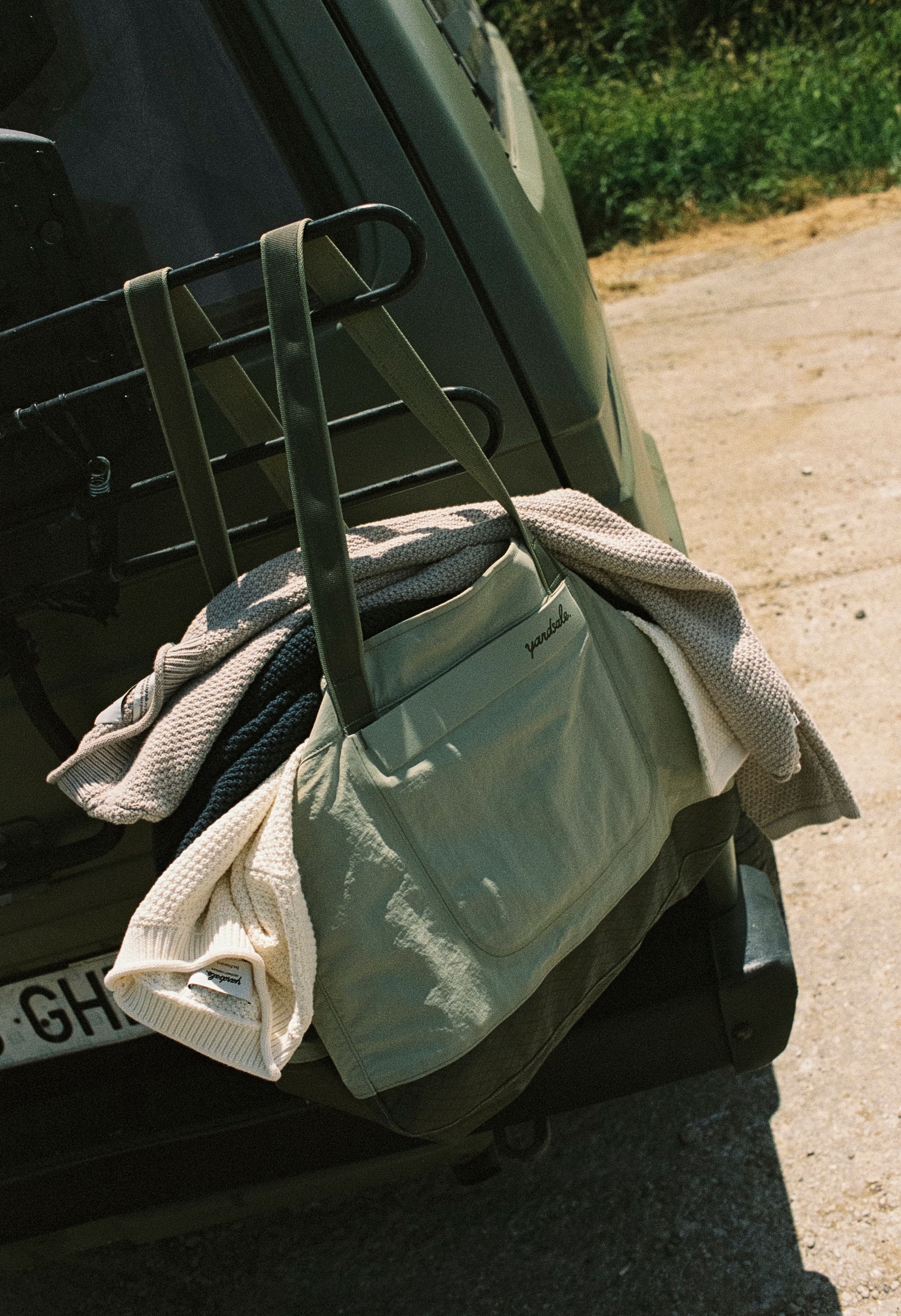 A close up image of the Verde Day Bag with the Cotton Surf Sweater