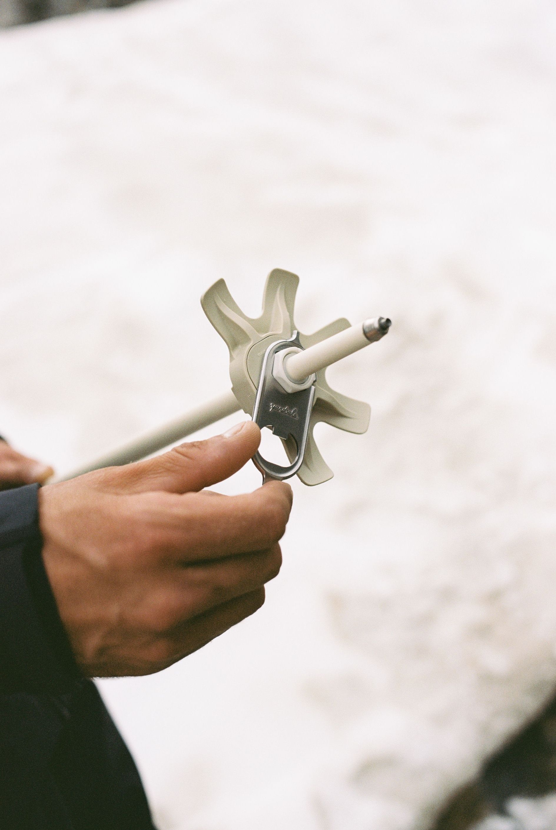 An image of someone tightening a powder basket