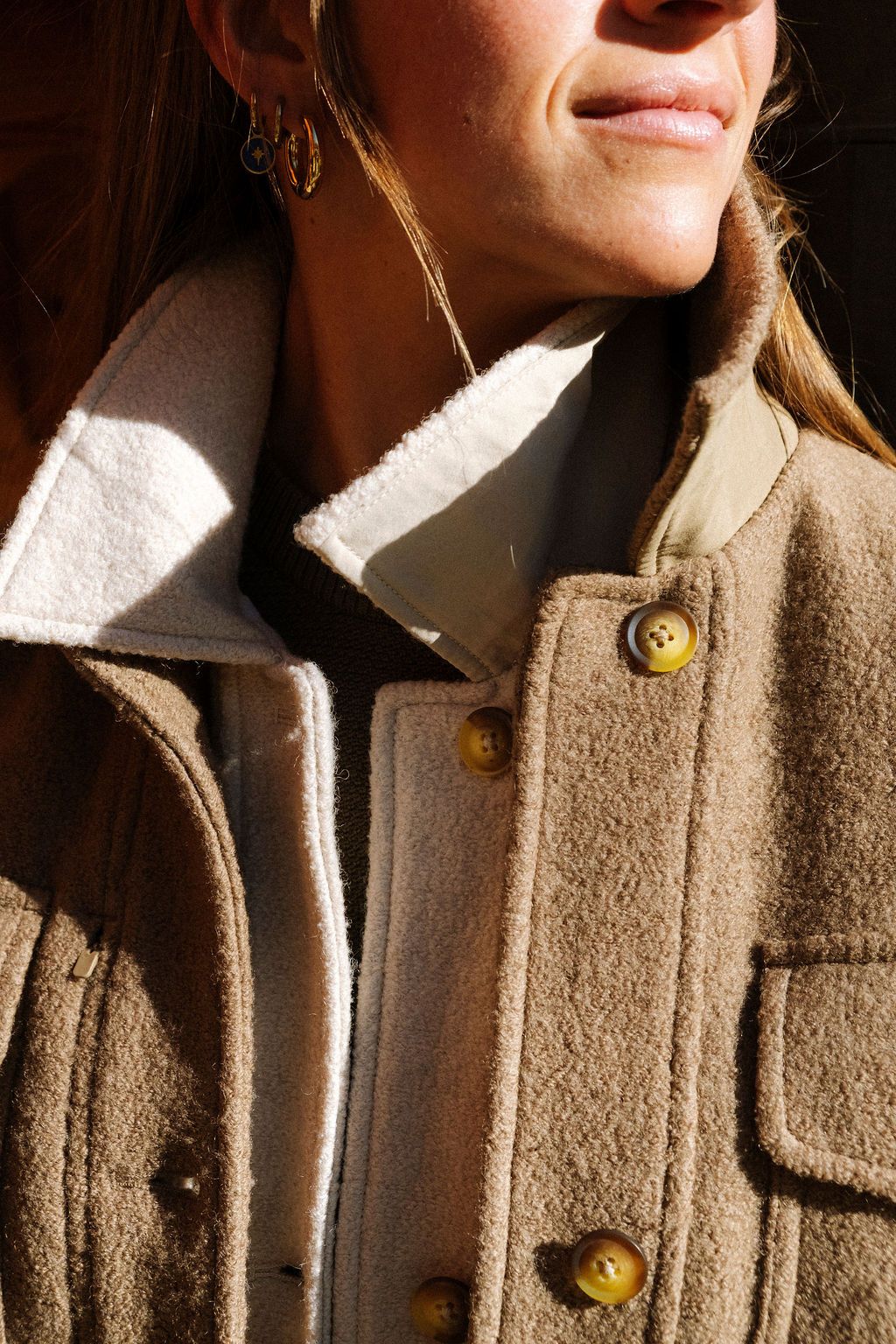 A woman with multiple jackets on