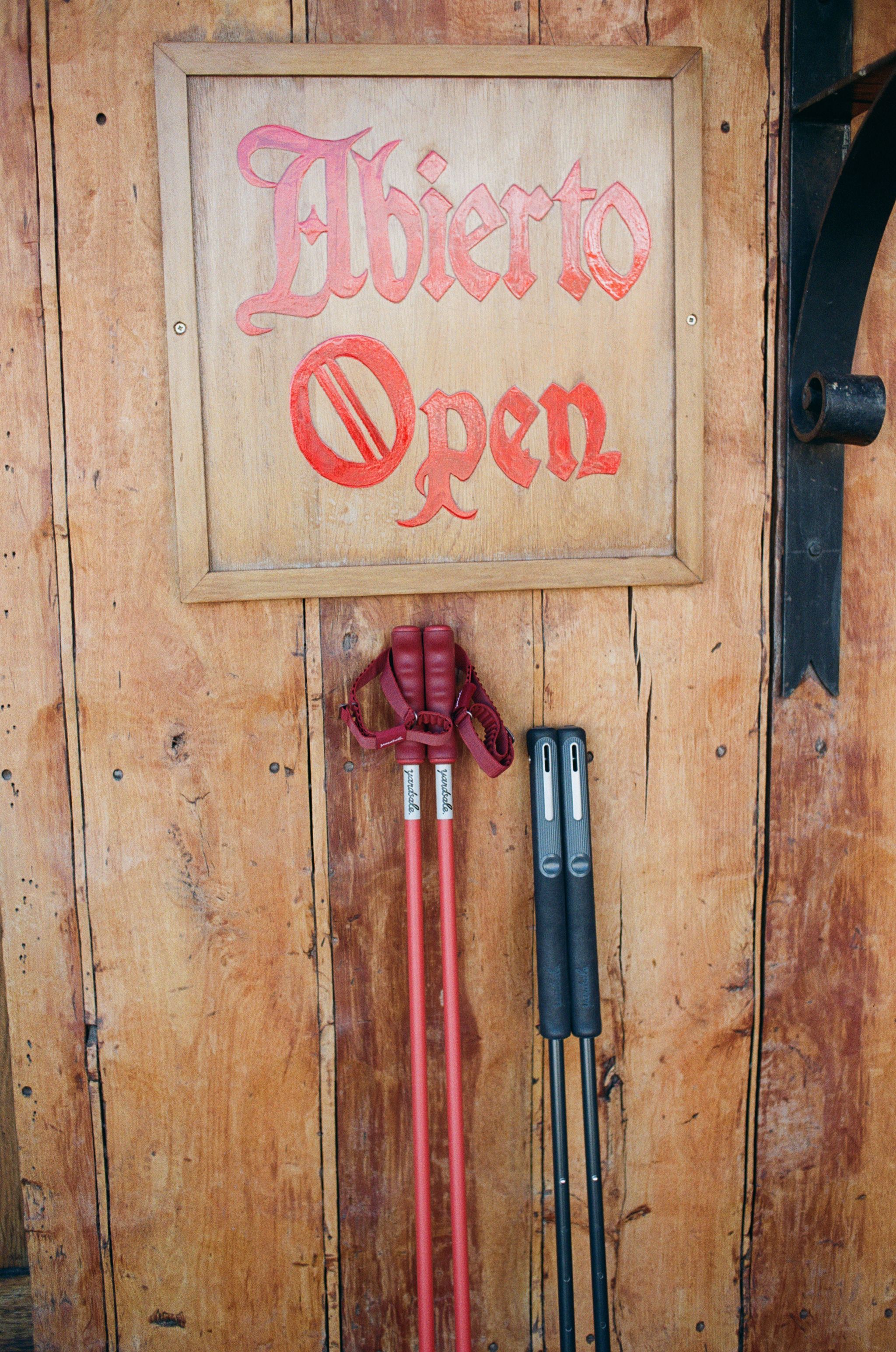 An image of ski poles resting on a cabin wall