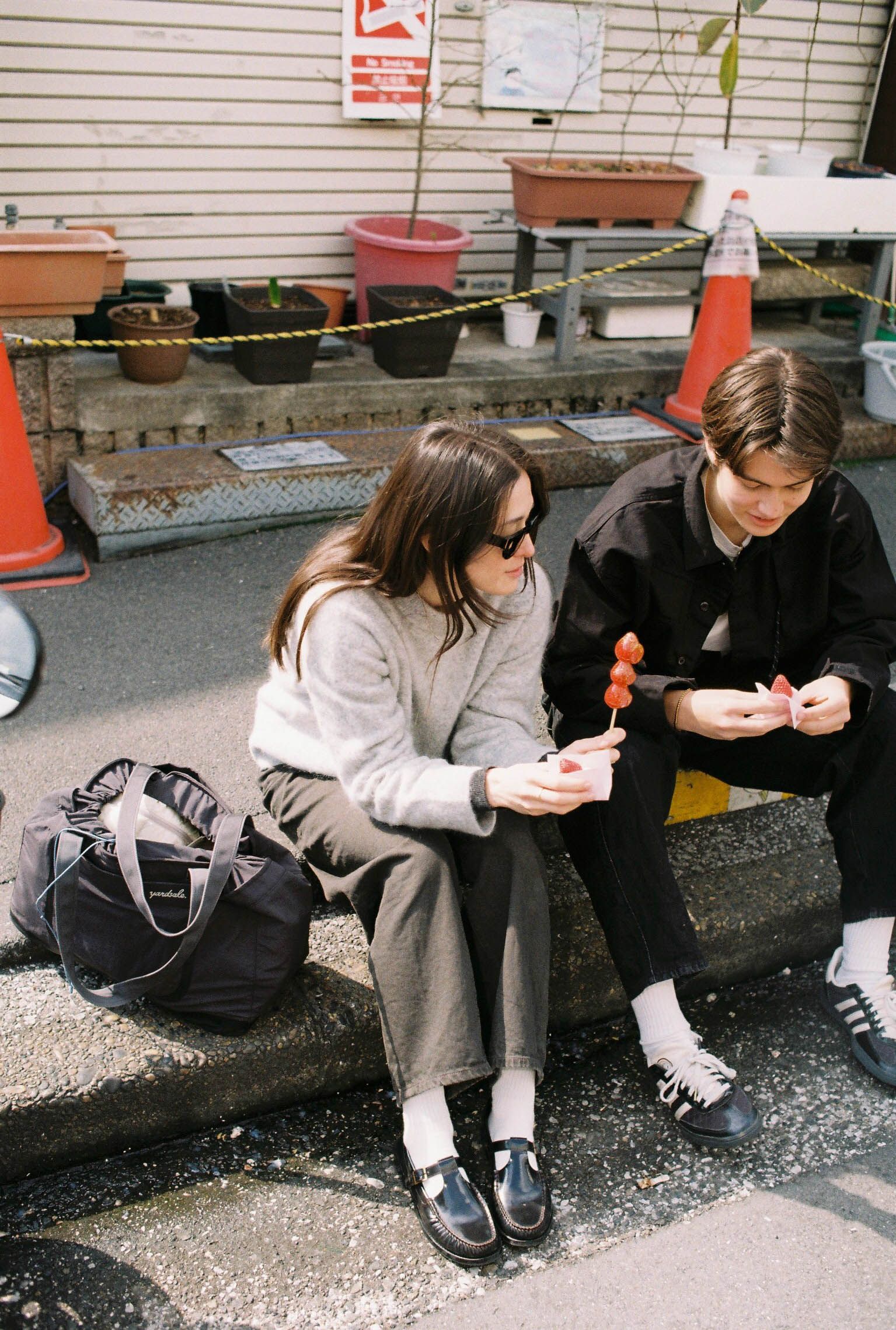 An image of people in Tokyo eating sushi with a 20L Day Bag