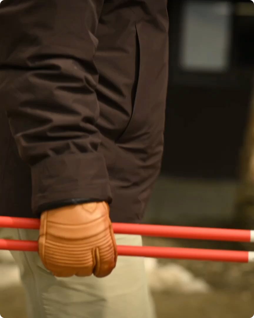 An image of a hand holding poles horizontally