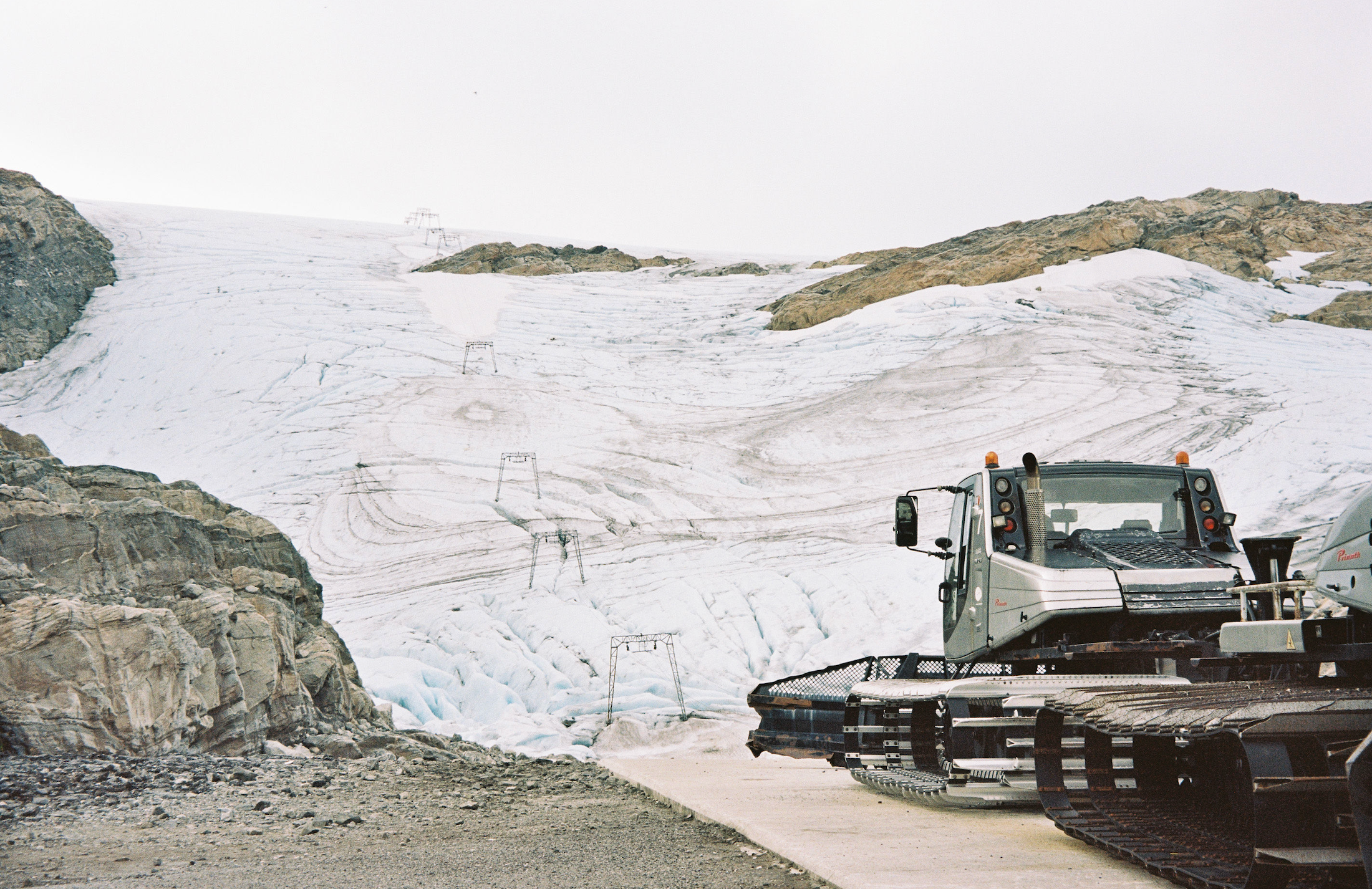 An image of a snow cat near a ski hill
