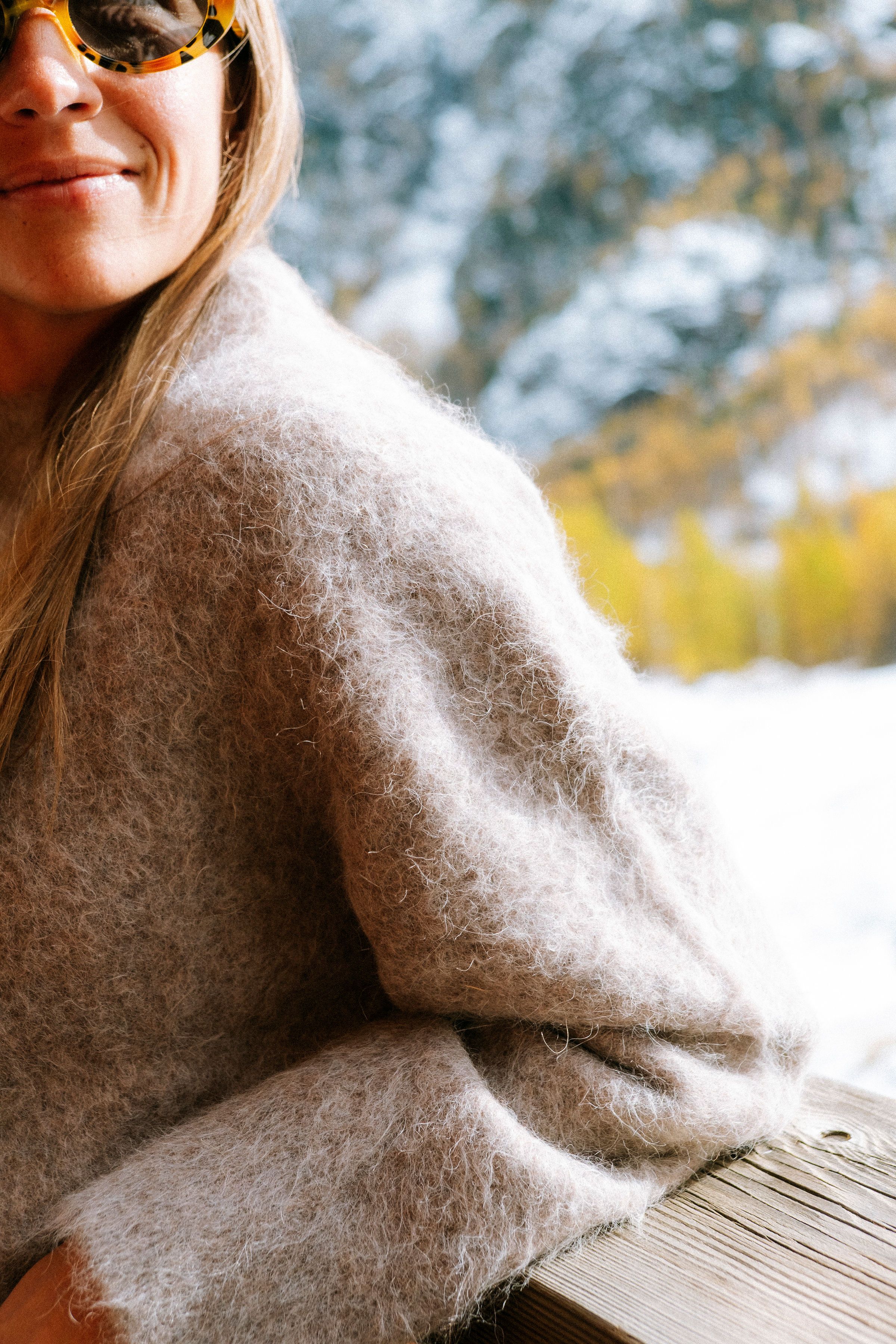 An image of a woman in a cozy alpaca sweater