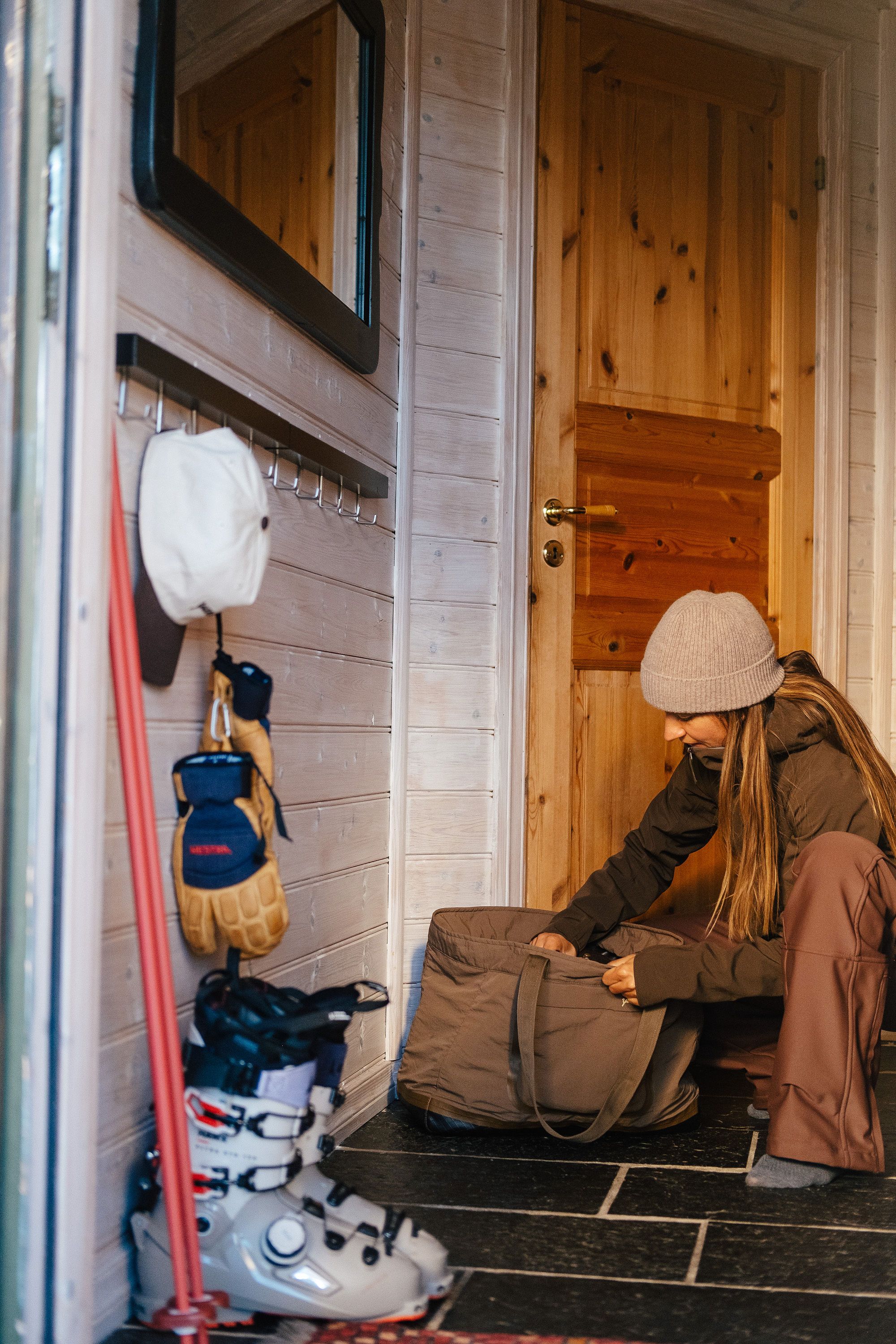A woman next to some ski gear