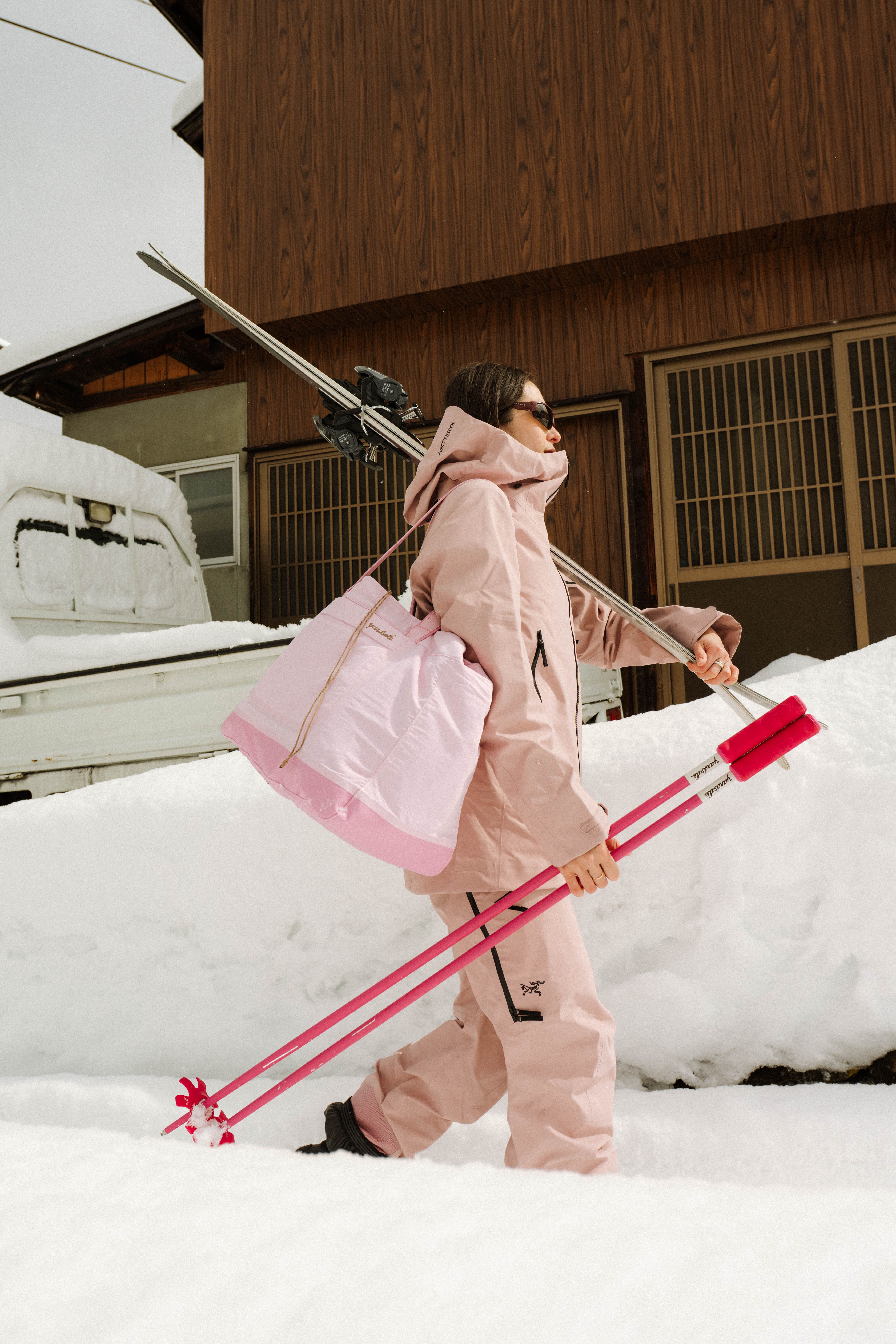 An image of a person walking with Yardsale ski poles and a Day Bag