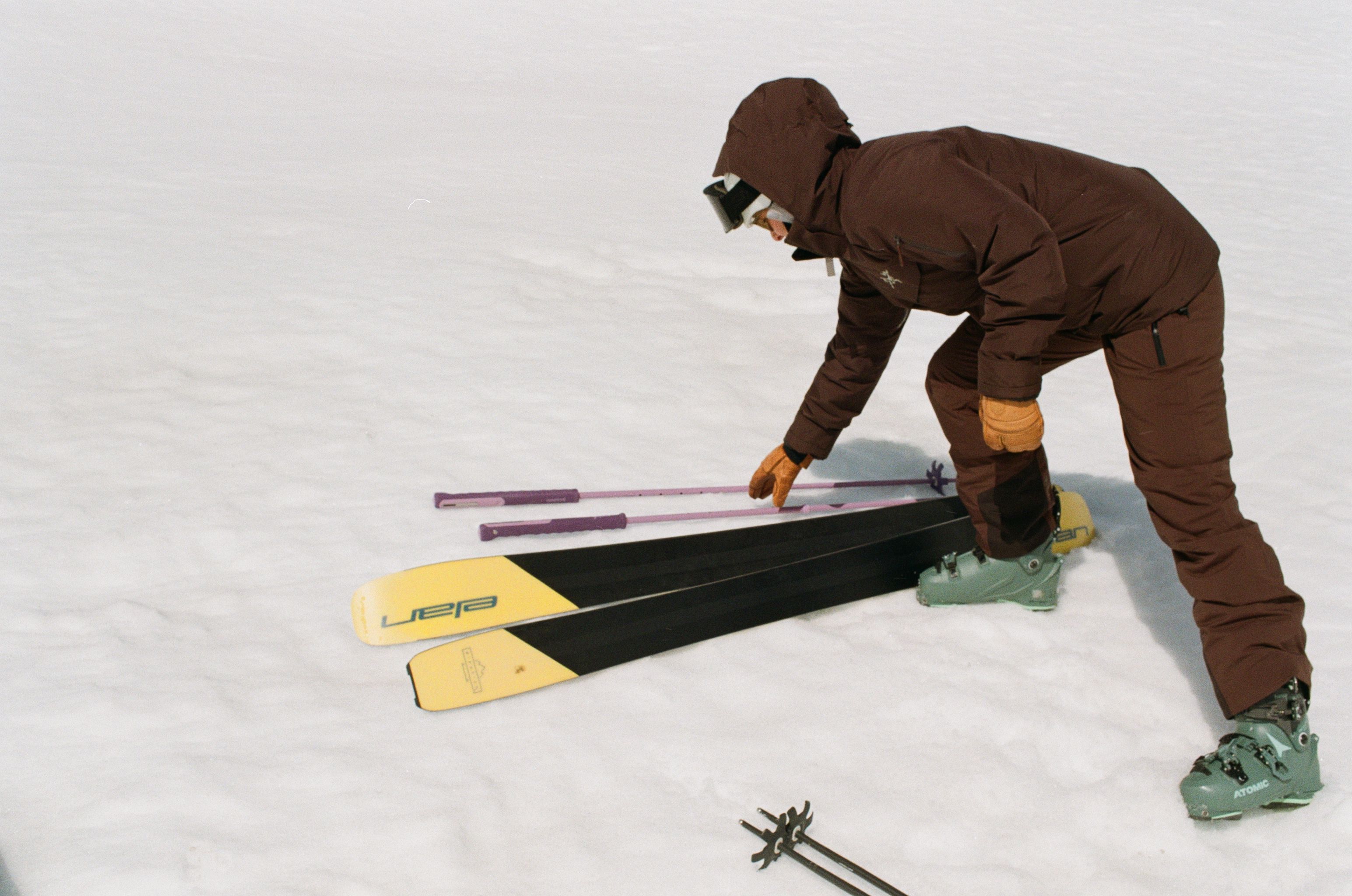 An image of a skier picking up backcountry ski poles