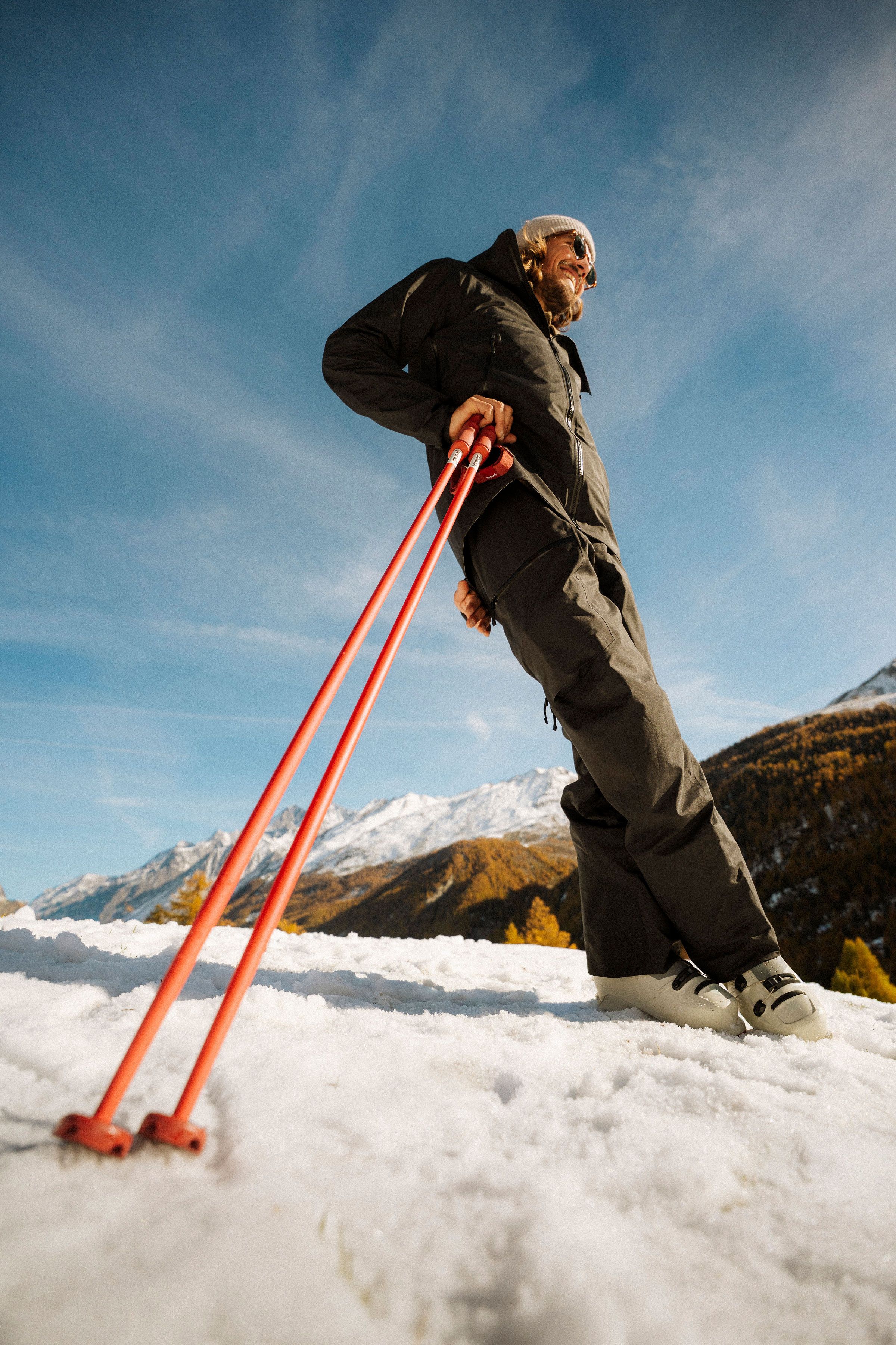 An image of a person leaning on ski poles in the snow