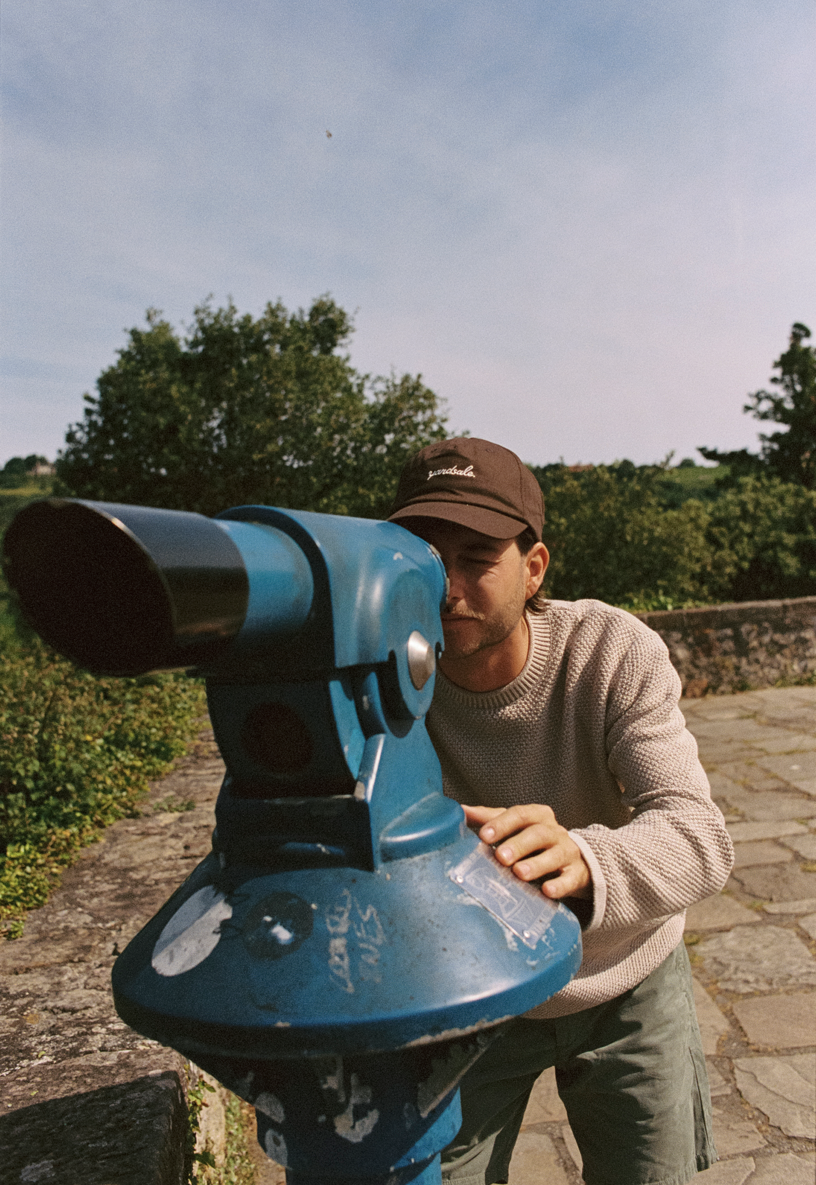 An image of a man looking through a telescope