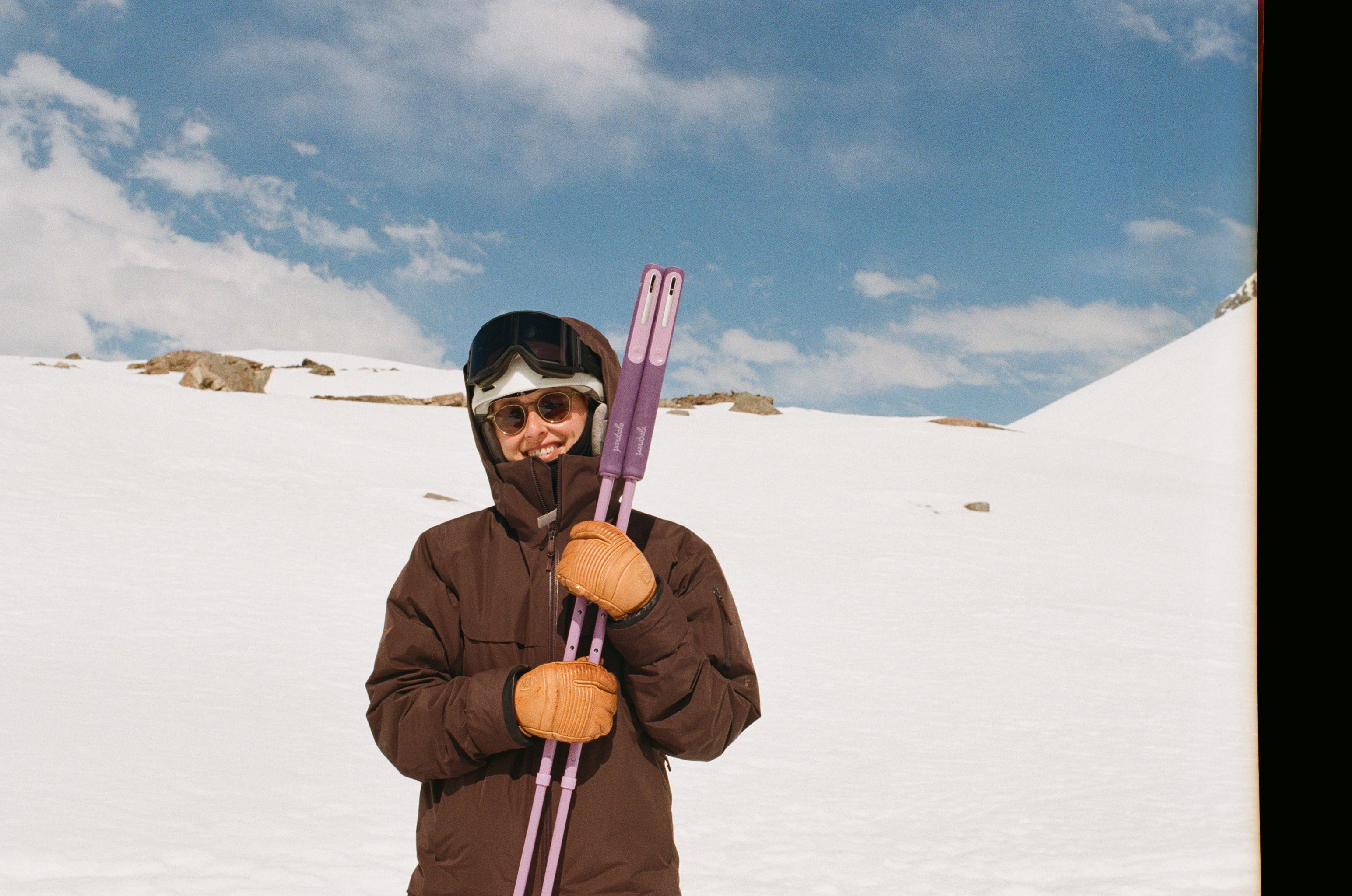 An image of a person with purple ski poles
