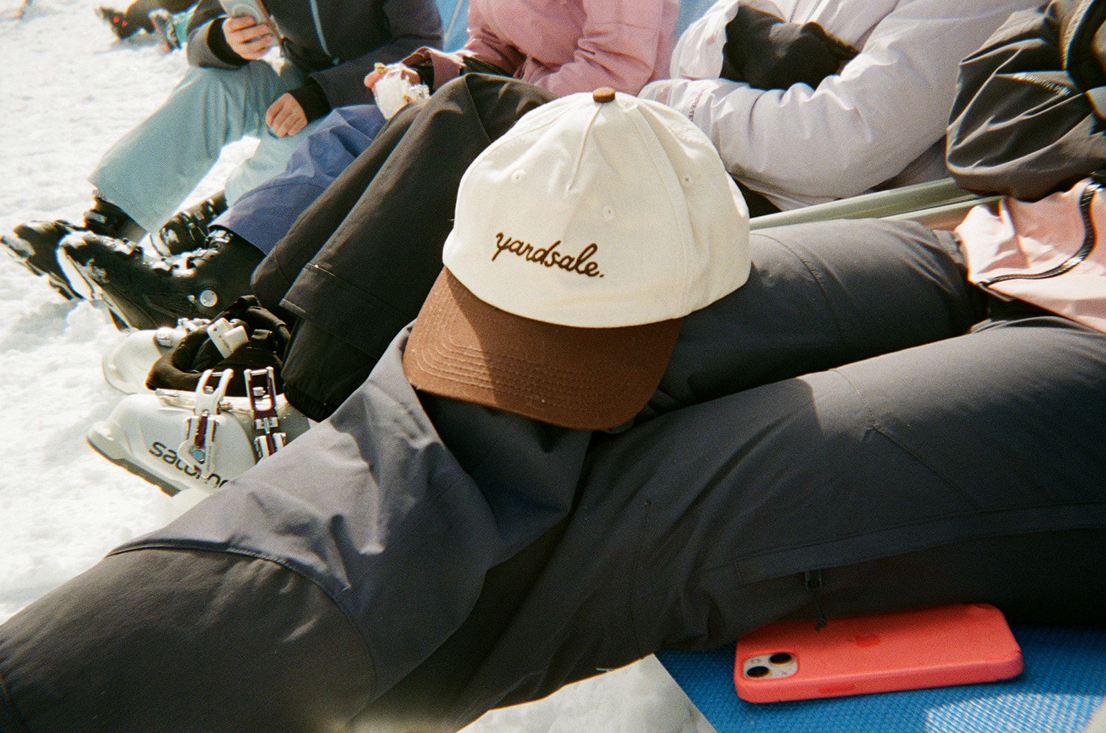 An Image of a hat resting on a person's legs