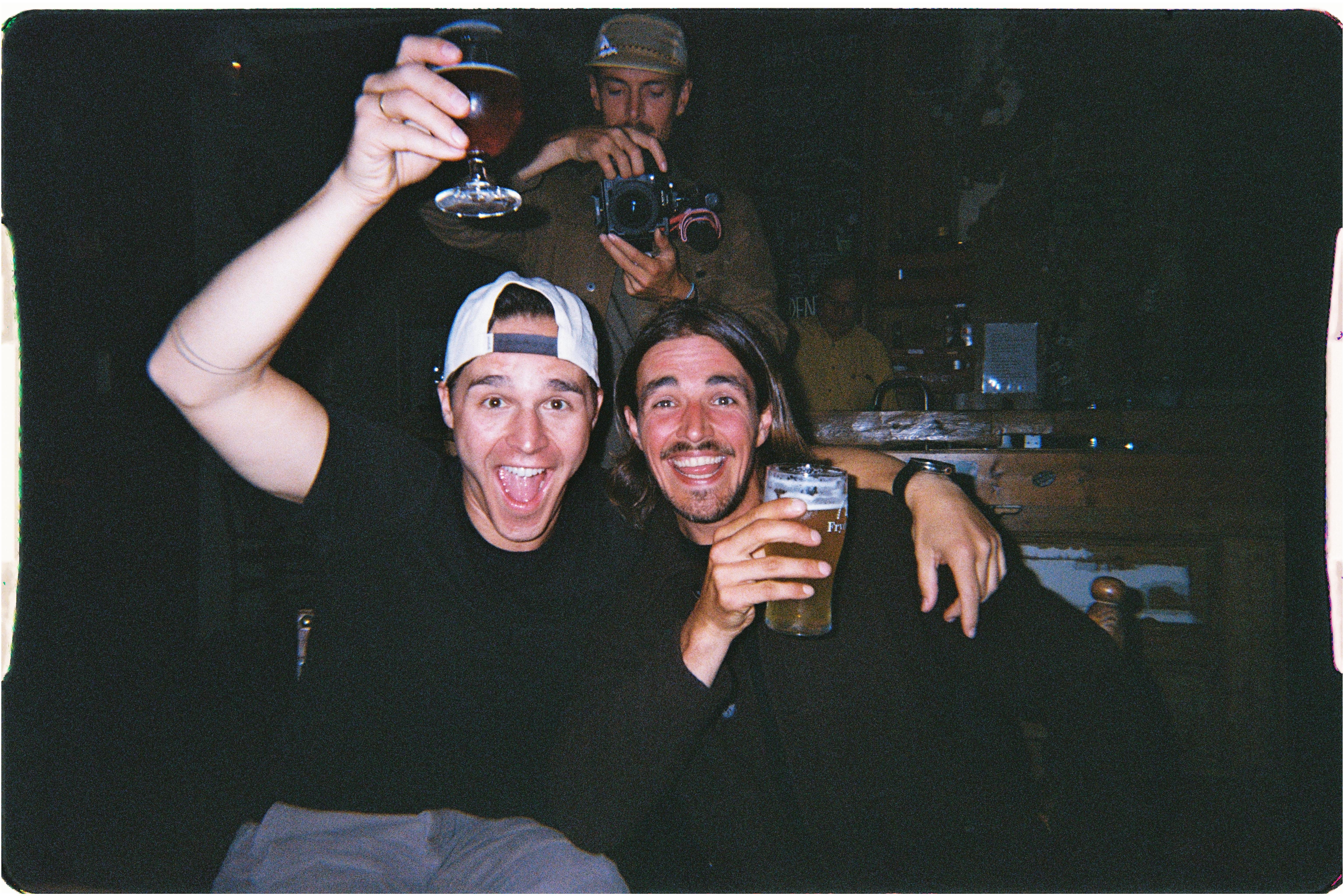 An image of two people raising beer glasses