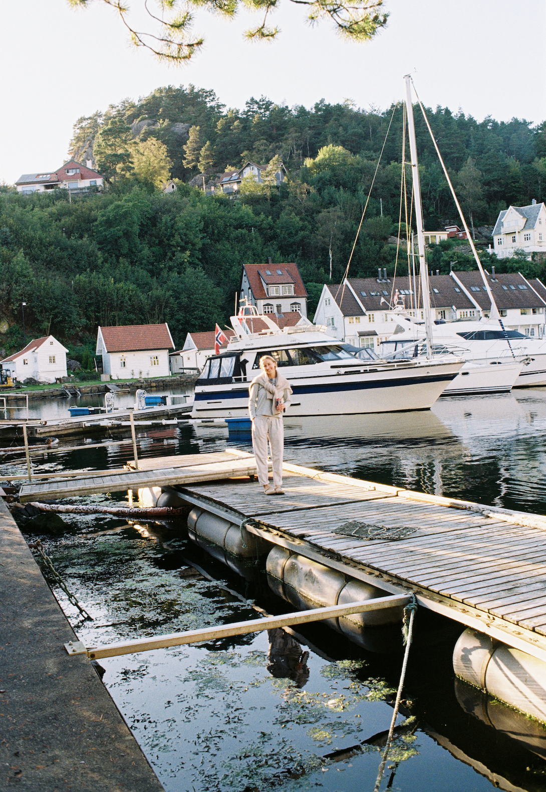 An image of a person standing on a boat dock
