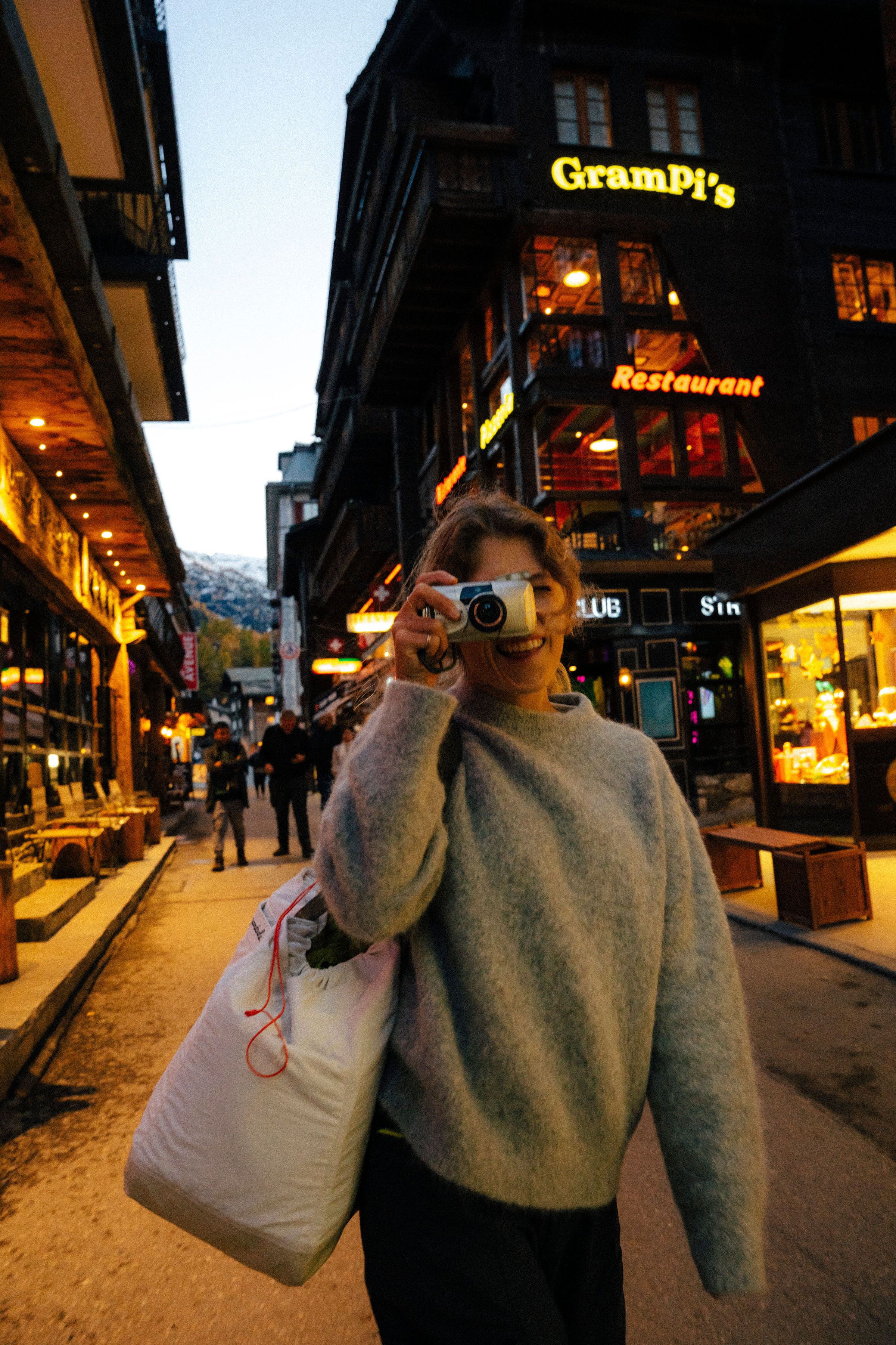 An image of a woman in town with an alpaca wool sweater on