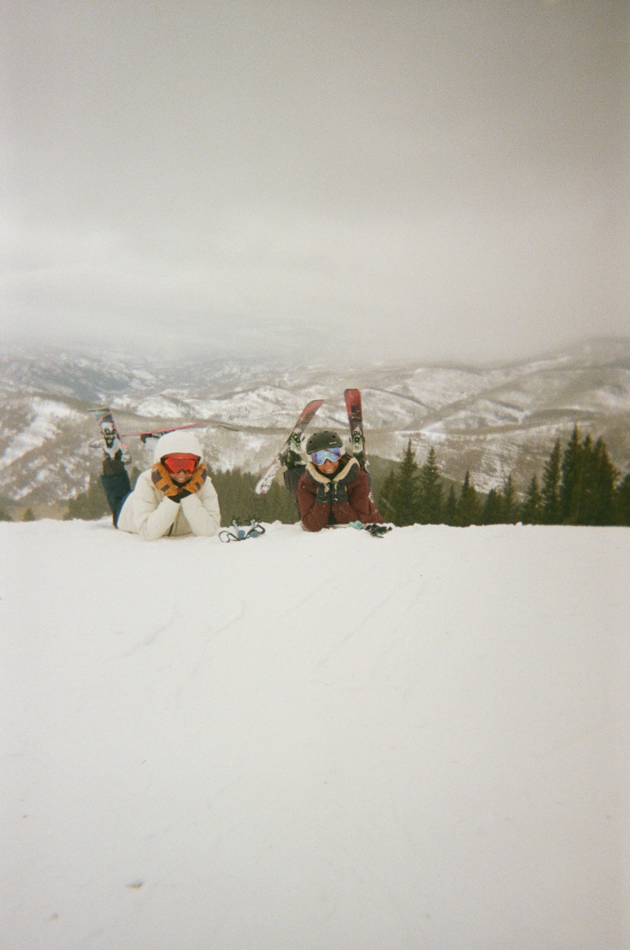 An image of two people with their legs crossed on the mountain