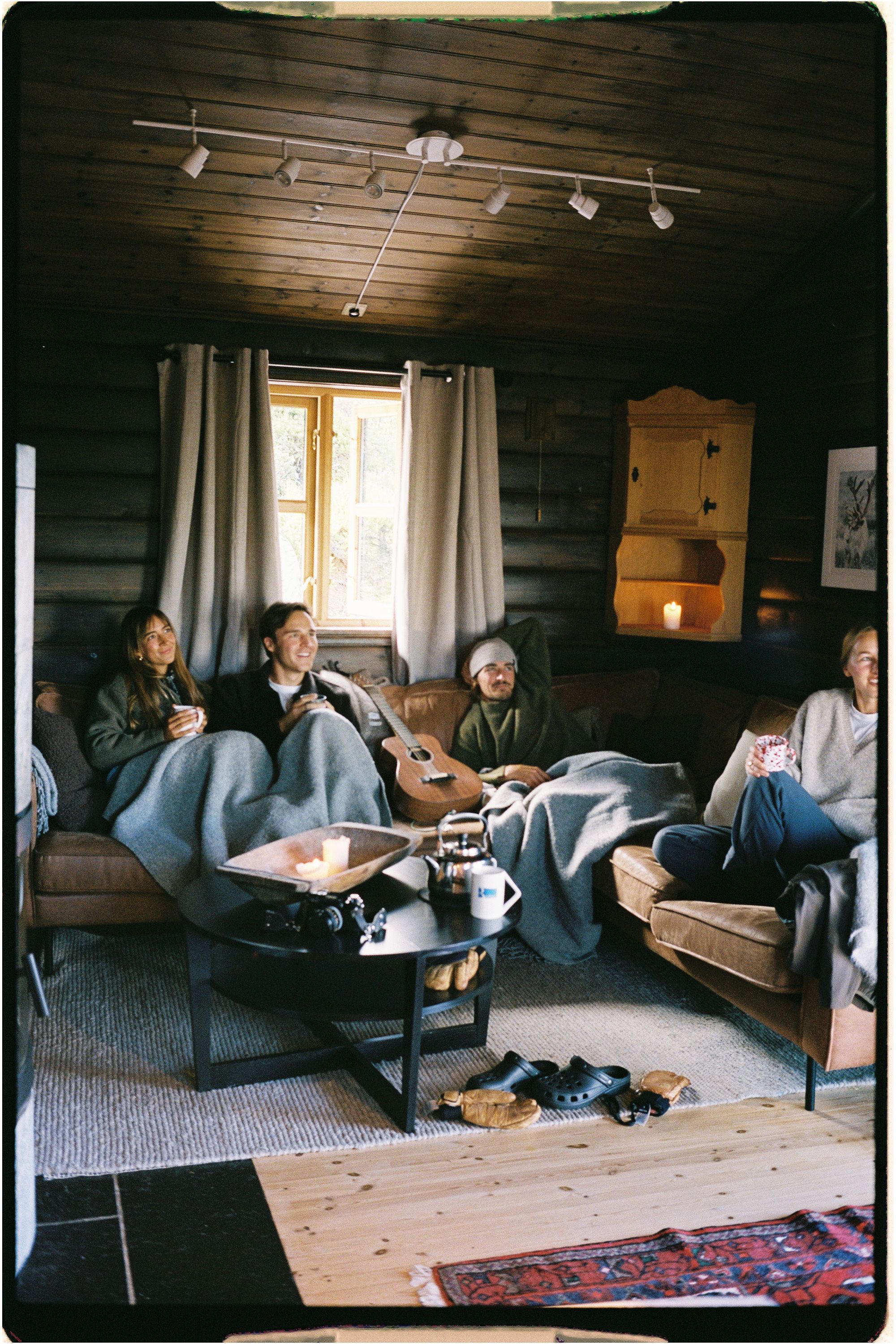 A group of people in a living room drinking coffee