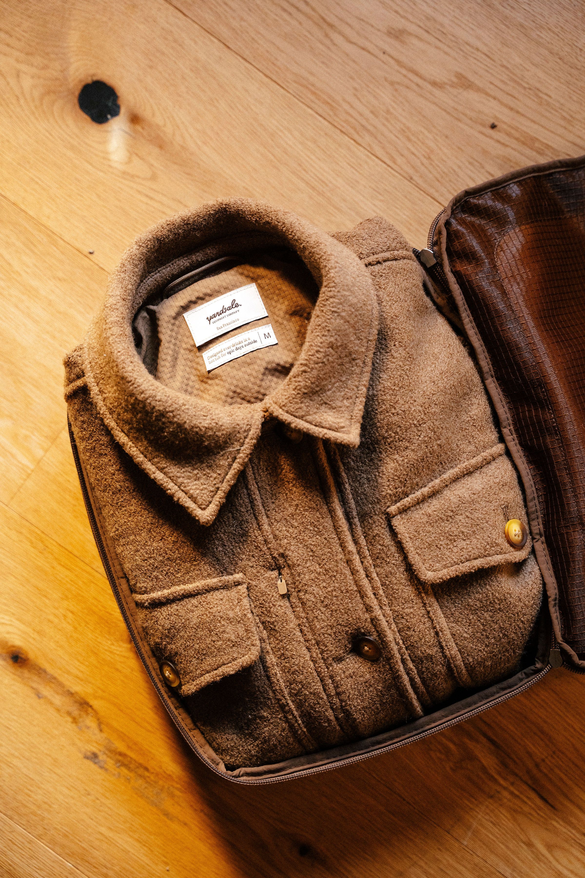 An image of a coat inside of a packing cube