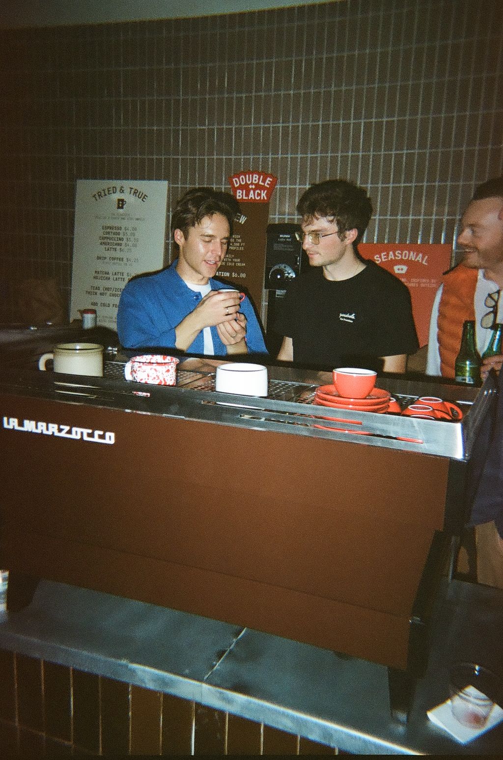 Image of people next to an espresso machine