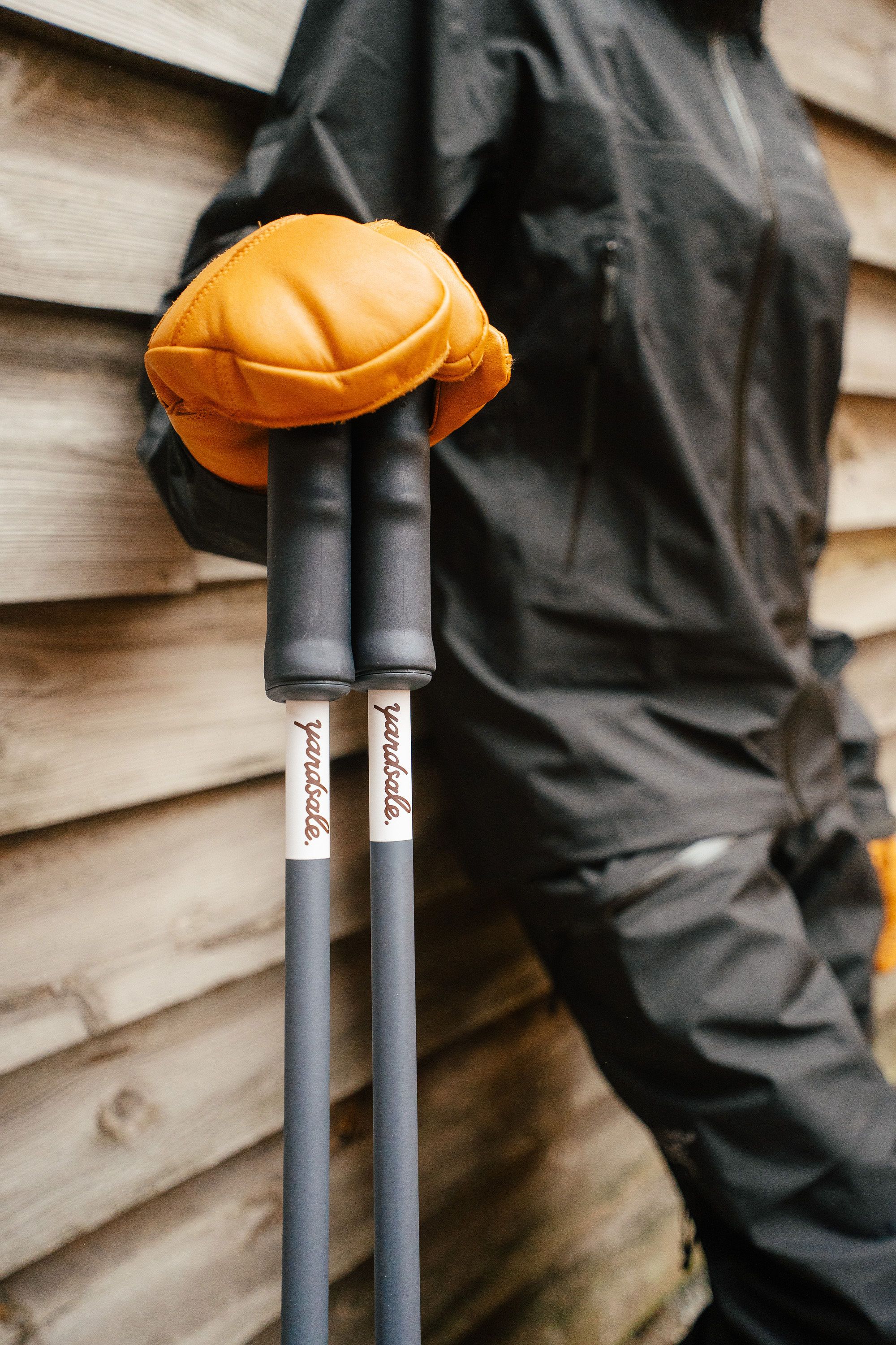 An image of a person holding ski poles on the snow