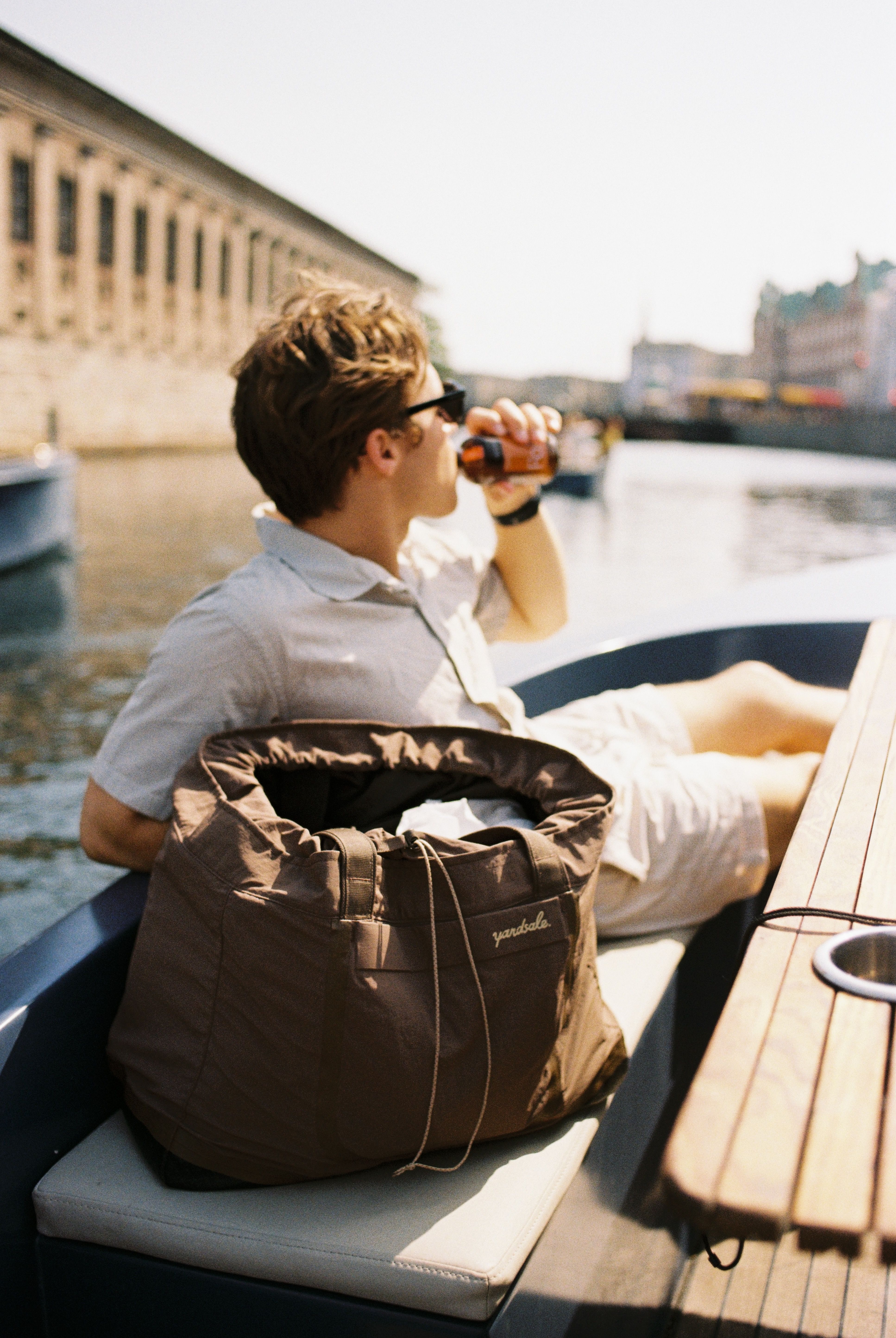 A bag on a boat with a person in the background