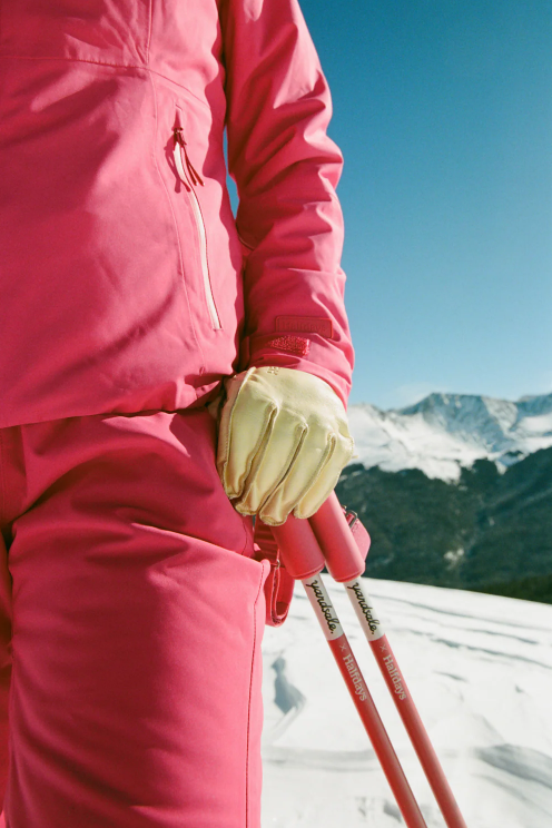 An image of a ski patroller holding ski poles