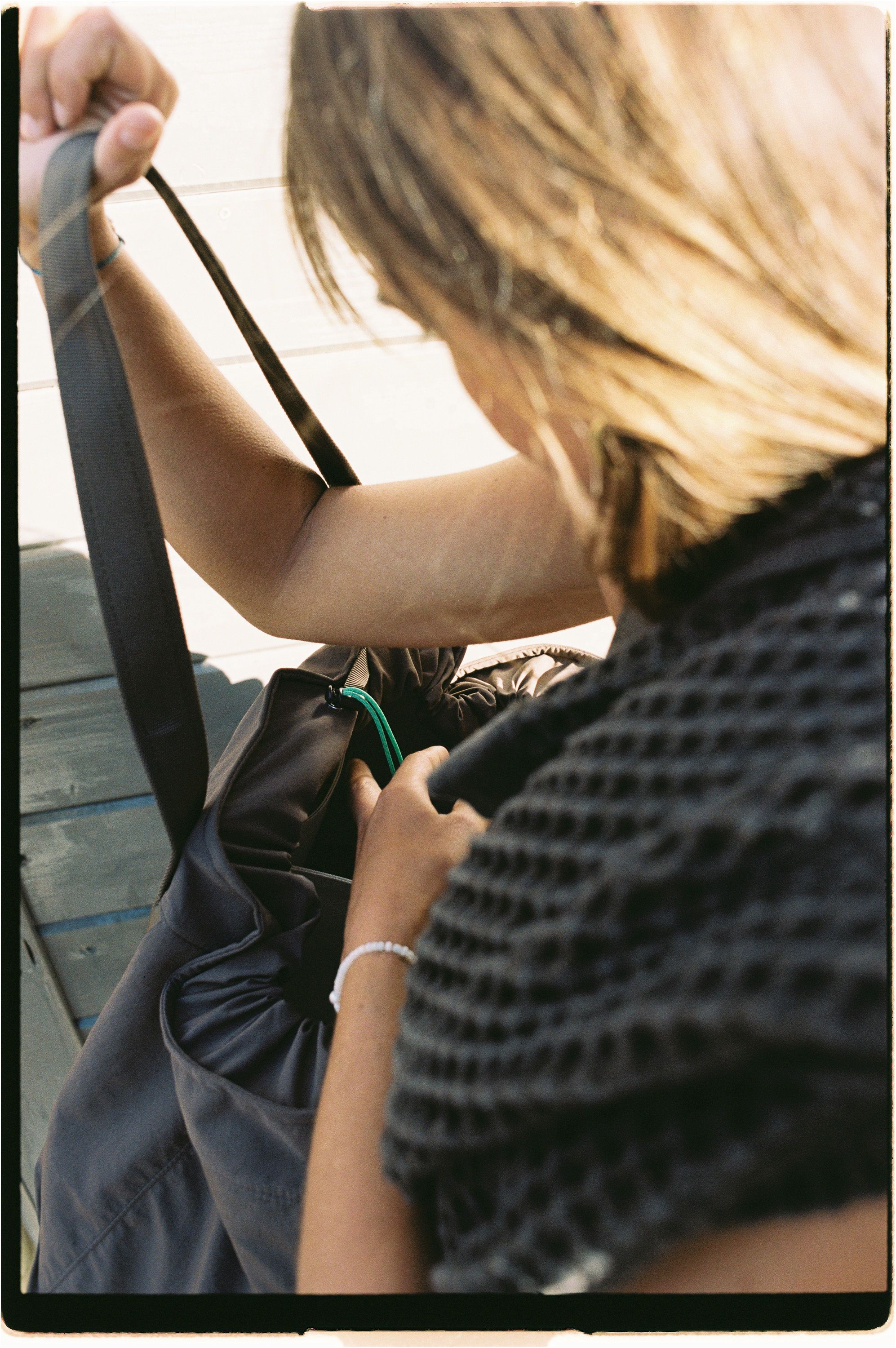 An image of someone cinching a bag closed