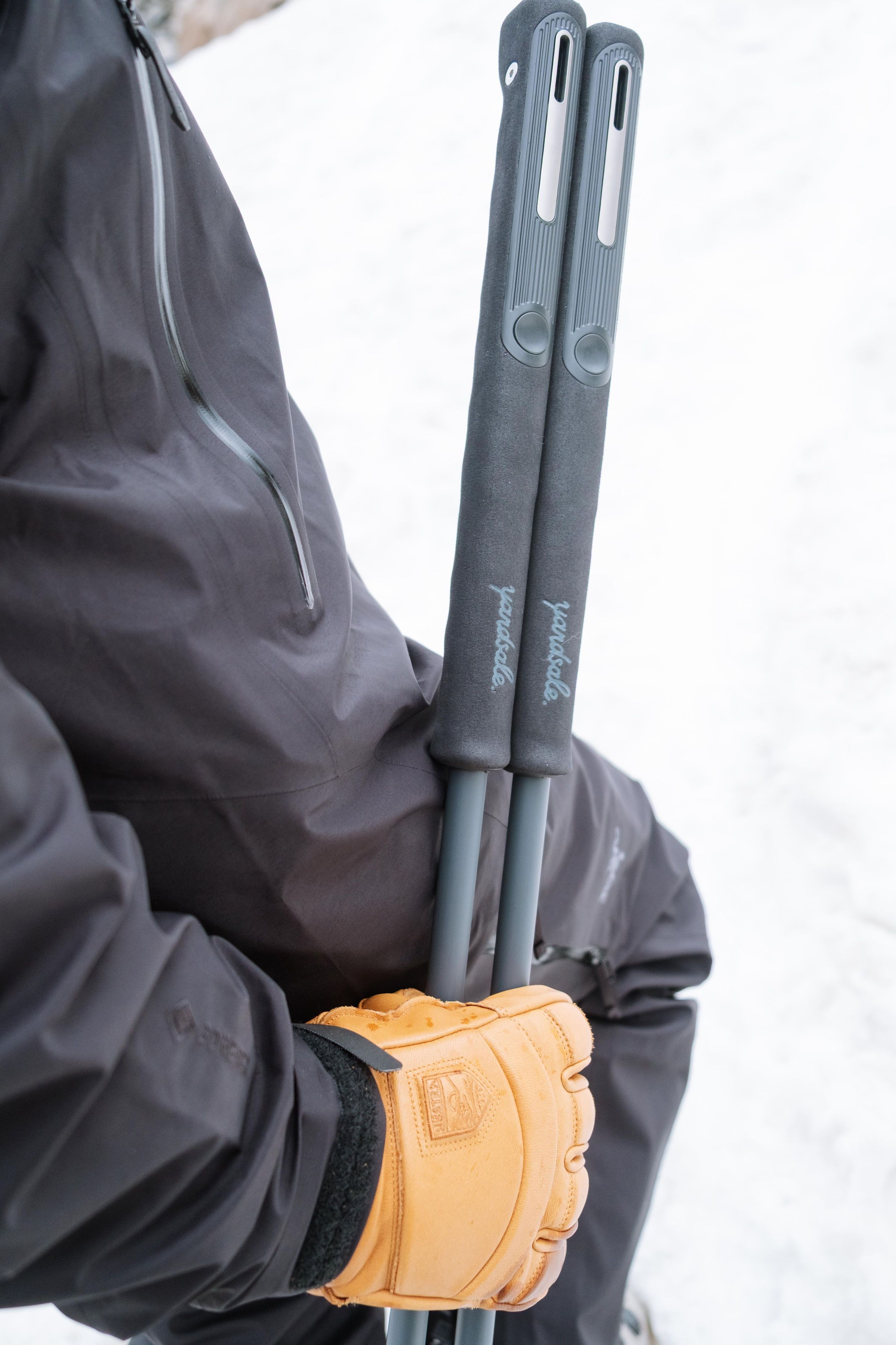 An image of ski poles with long goam grips in someone's hands