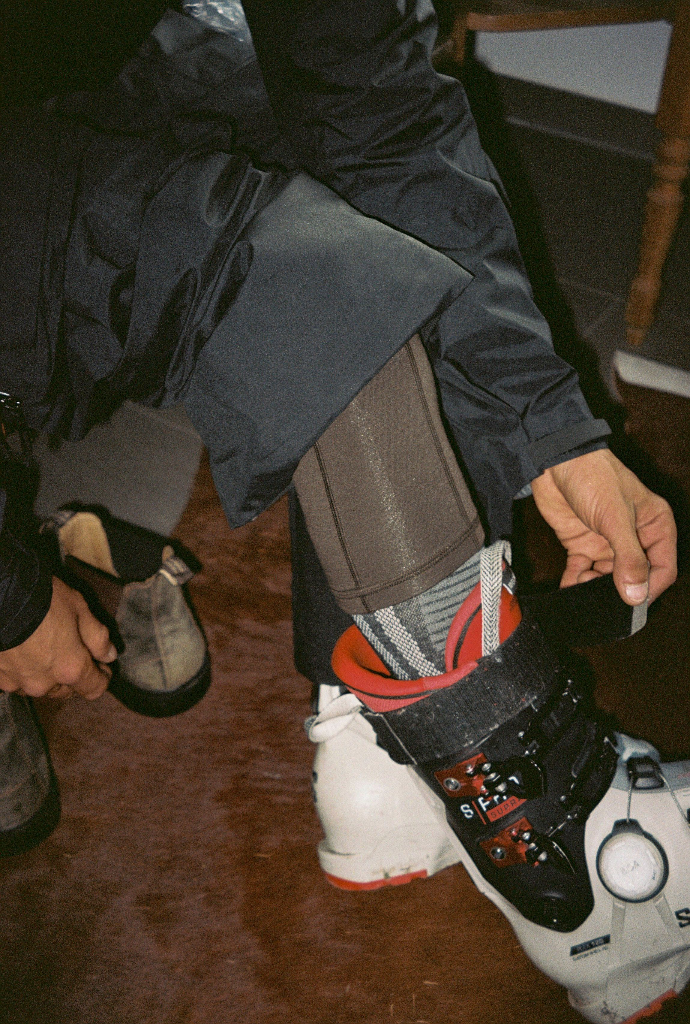An image of someone putting a ski boot on